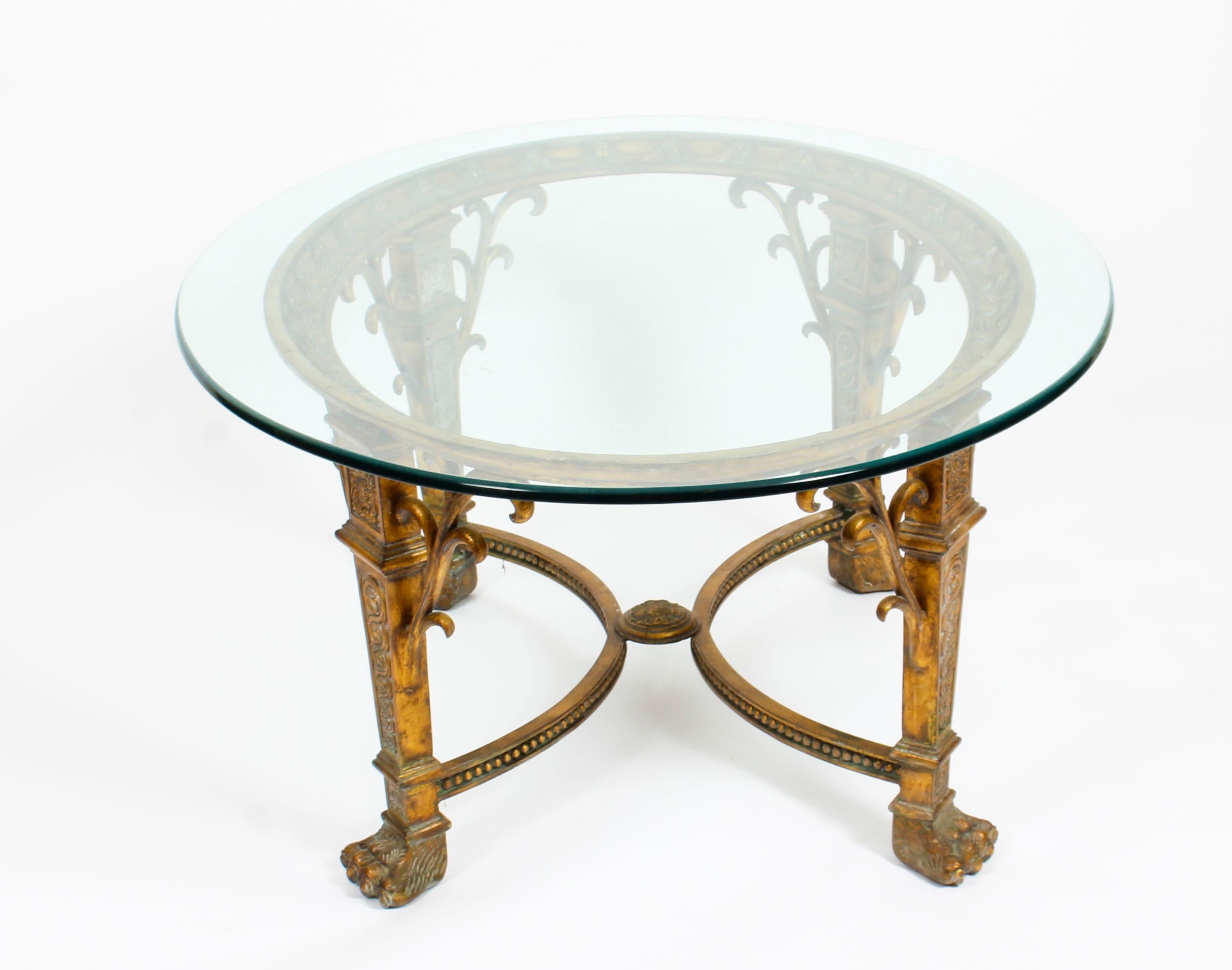 This is a truly stunning bronze framed coffee table in timeless Classical style, dating from the middle of the 20th Century.

The coffee table is of elegant oval shape and features a clear glass top. Decorated with magnificent bronze swags and