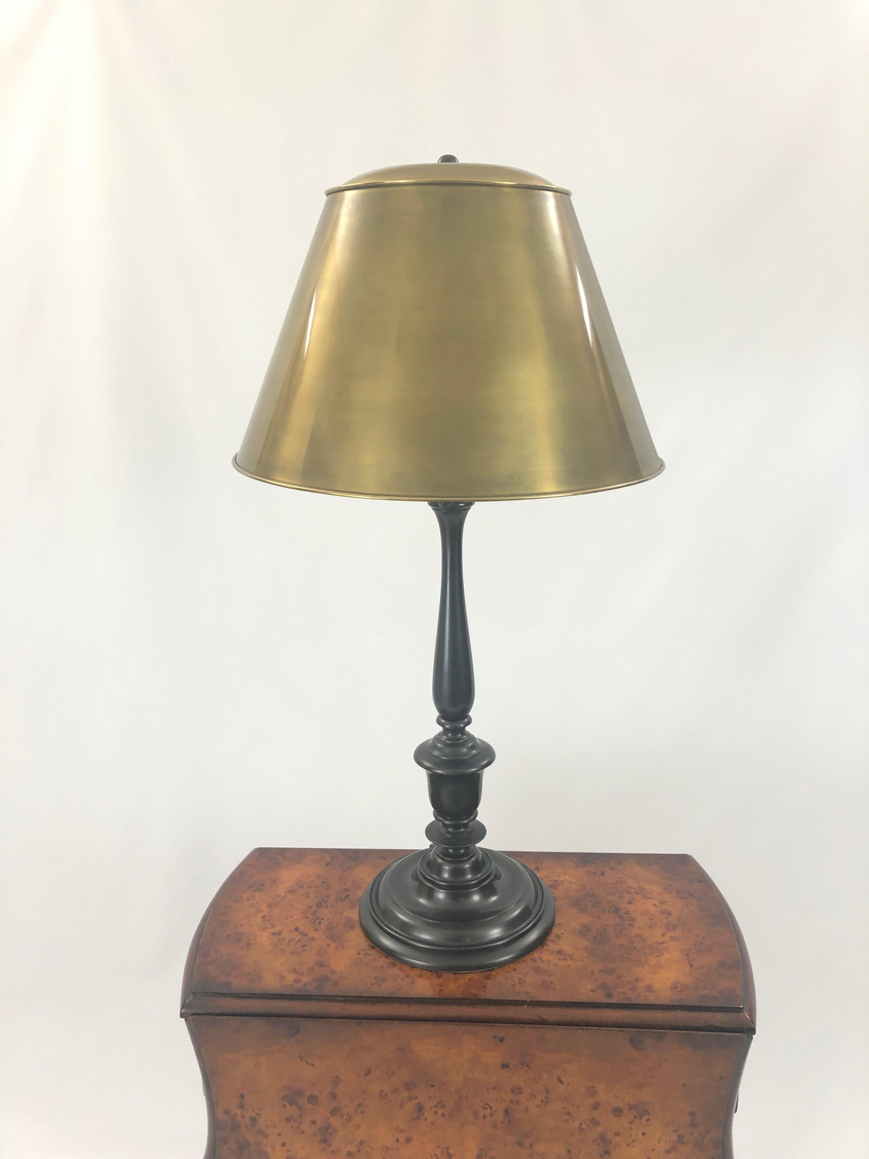 A gorgeous table lamps by Visual Comfort having a simple bronze columnar base and a superb brass shade. 60 watt in each socket.