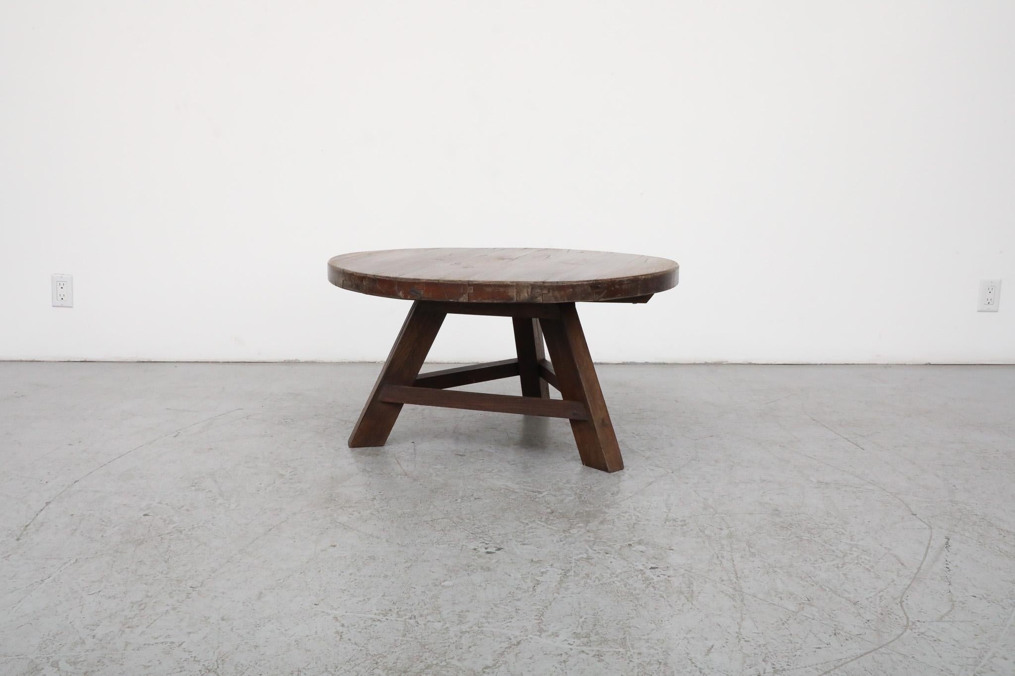 This Mid-Century, Brutalist, Pierre Chapo inspired solid oak side or coffee table is outfitted with a handsome and generous round top as well as a tripod style trestle base. It is in original condition with some visible wear, including some natural