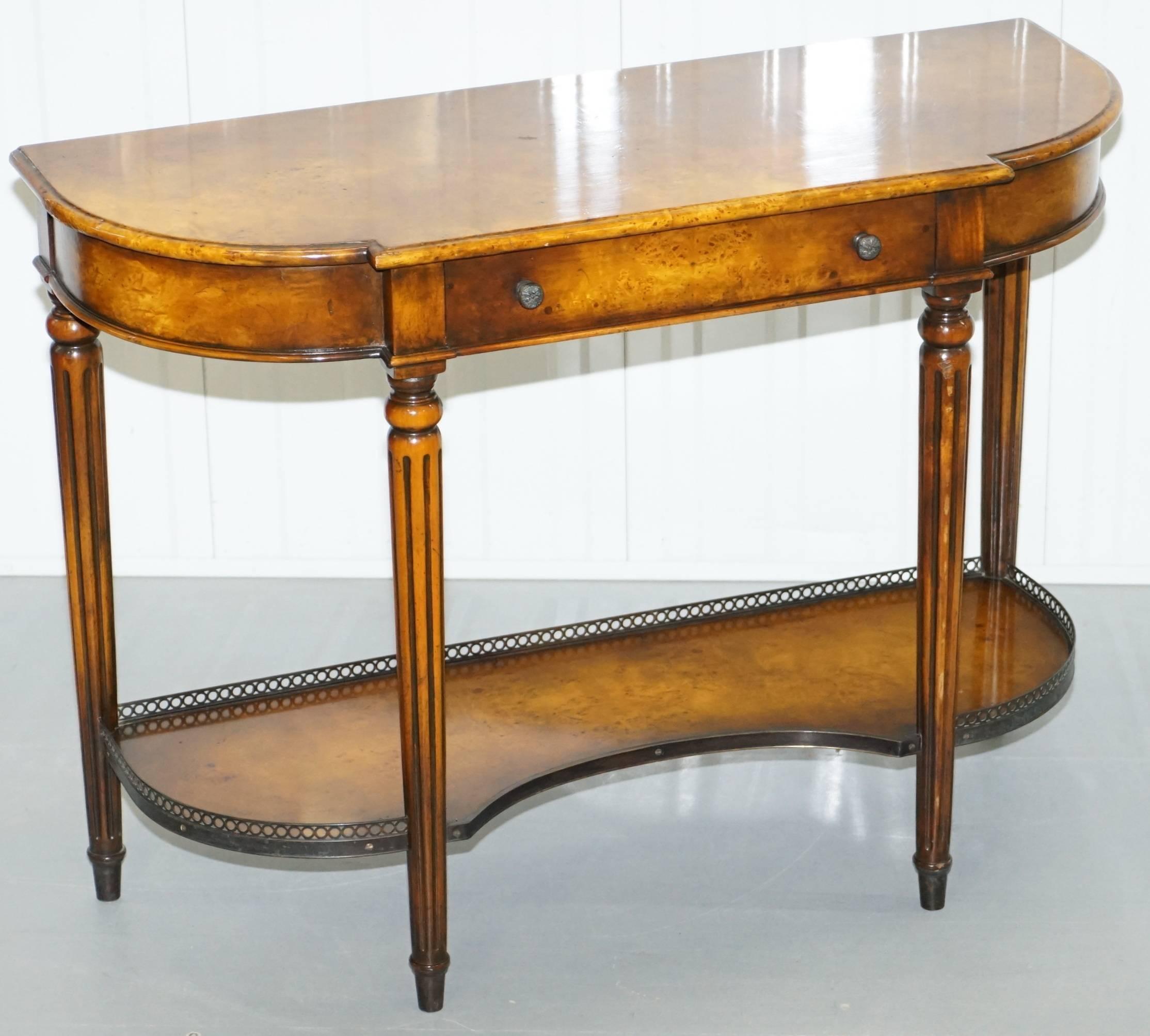 We are delighted to offer for sale this stunning burr walnut Theodore Alexander console table with single drawer and pierced fretwork detailing

A very good looking high end luxury piece in lightly restored condition throughout, there was one chip