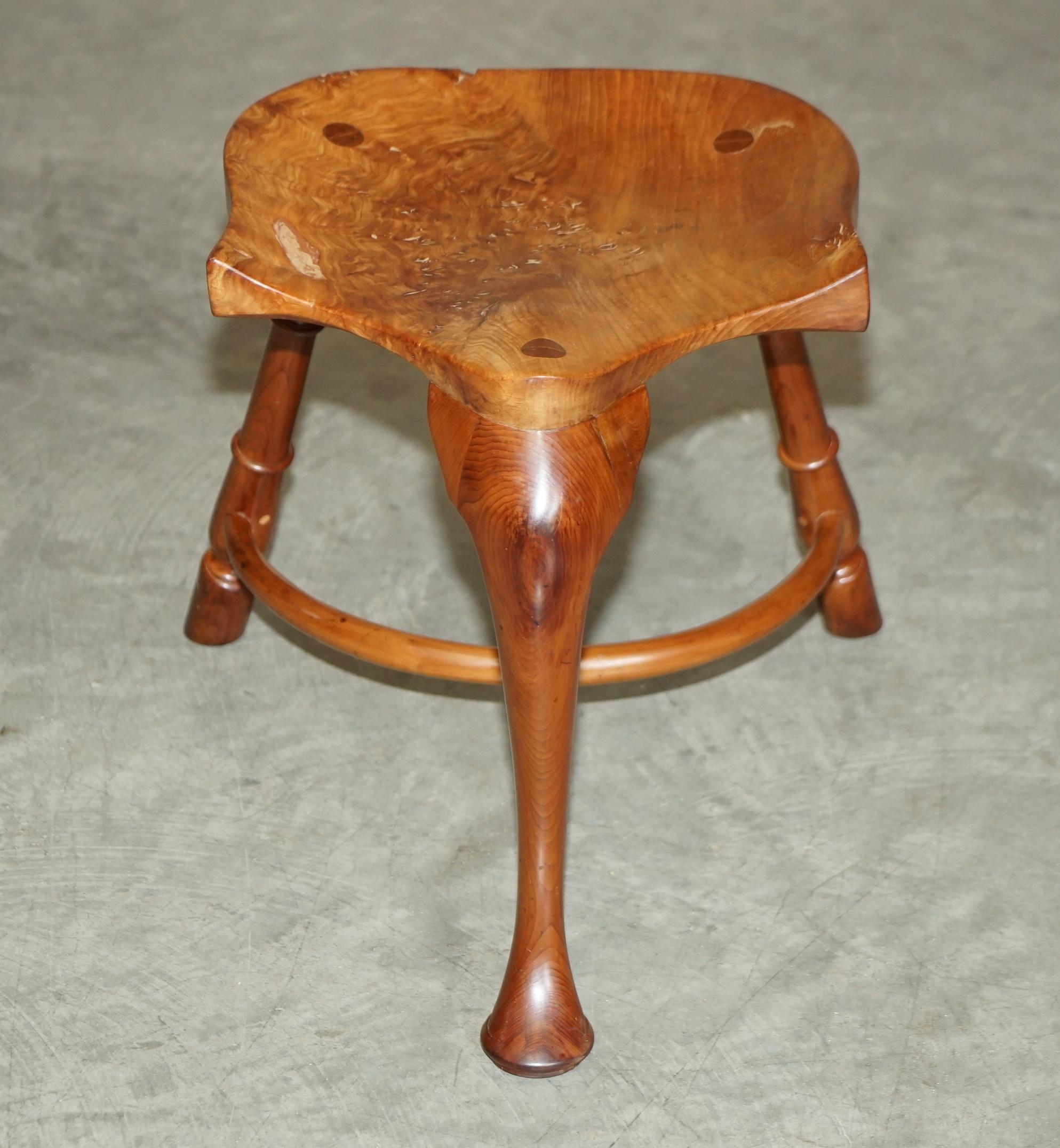 We are delighted to offer for sale this stunning burr yew wood vintage three legged stool with exquisite patina top.

A wonderful timber grain, the top is made from a solid slab of burr yew which has been beautifully crafted and sculpted into a