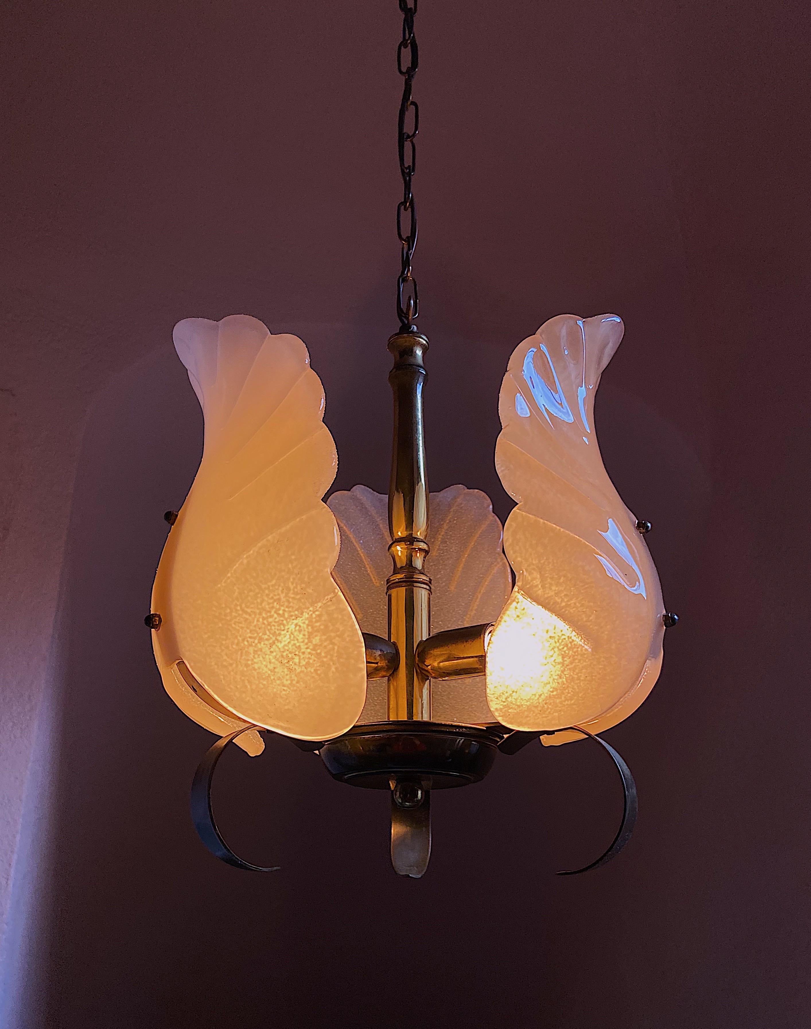 Very glamorous chandelier designed by Carl Fagerlund for Orrefors, Sweden. The light features a polished brass frame with three stunning Murano glass leaves. The glass have a matte frosted relief on the inside and are shiny on the outside. This