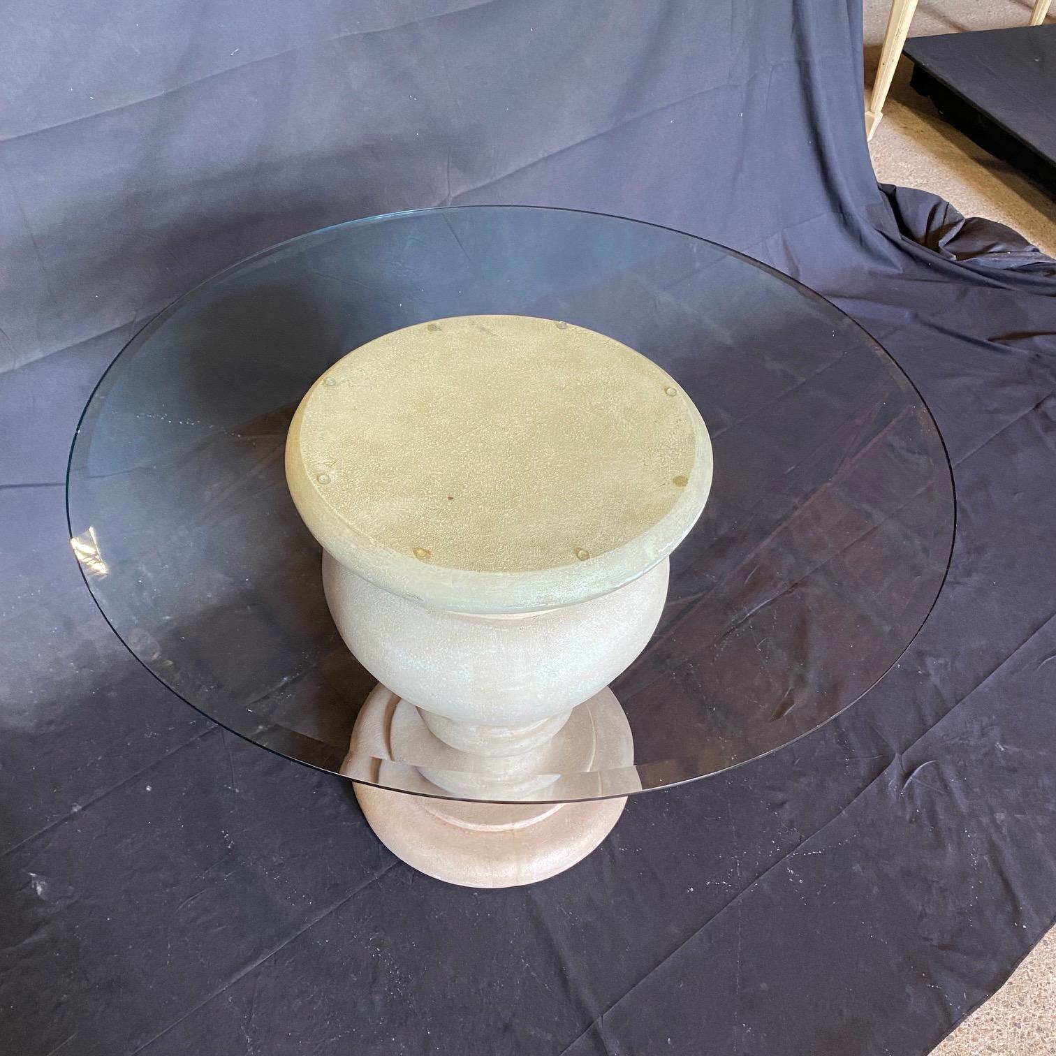 An impressive large carved stone vintage urn now used with a glass top to create a center table is of an adaptable size, suitable as a center focal table, dining table for four, or as a lovely side table. The urn has a lovely surface and patina and