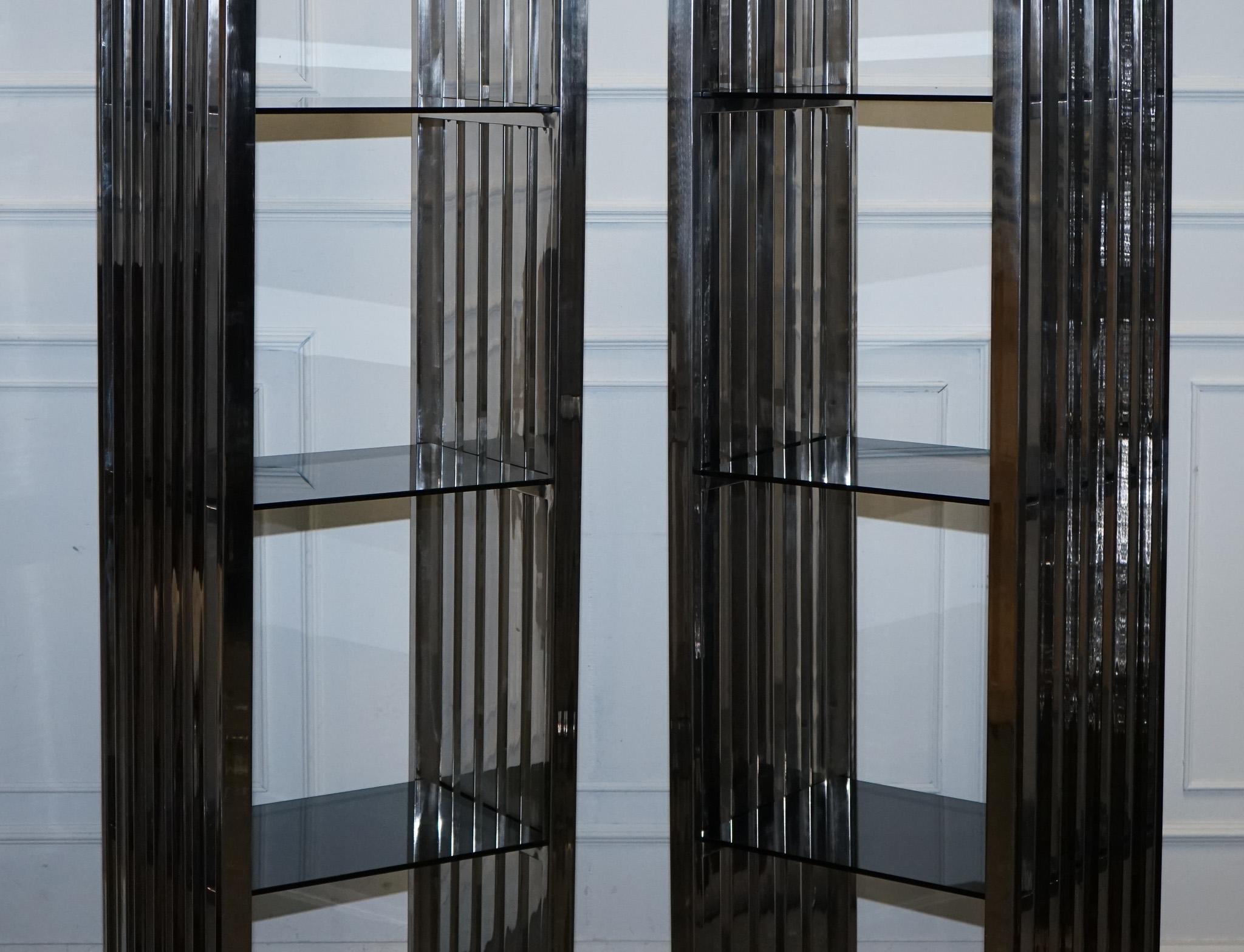 British STUNNING CASA PADRINO STAINLESS STEEL PAiR OF BOOKCASES AND SMOKED GLASS SHELFS For Sale