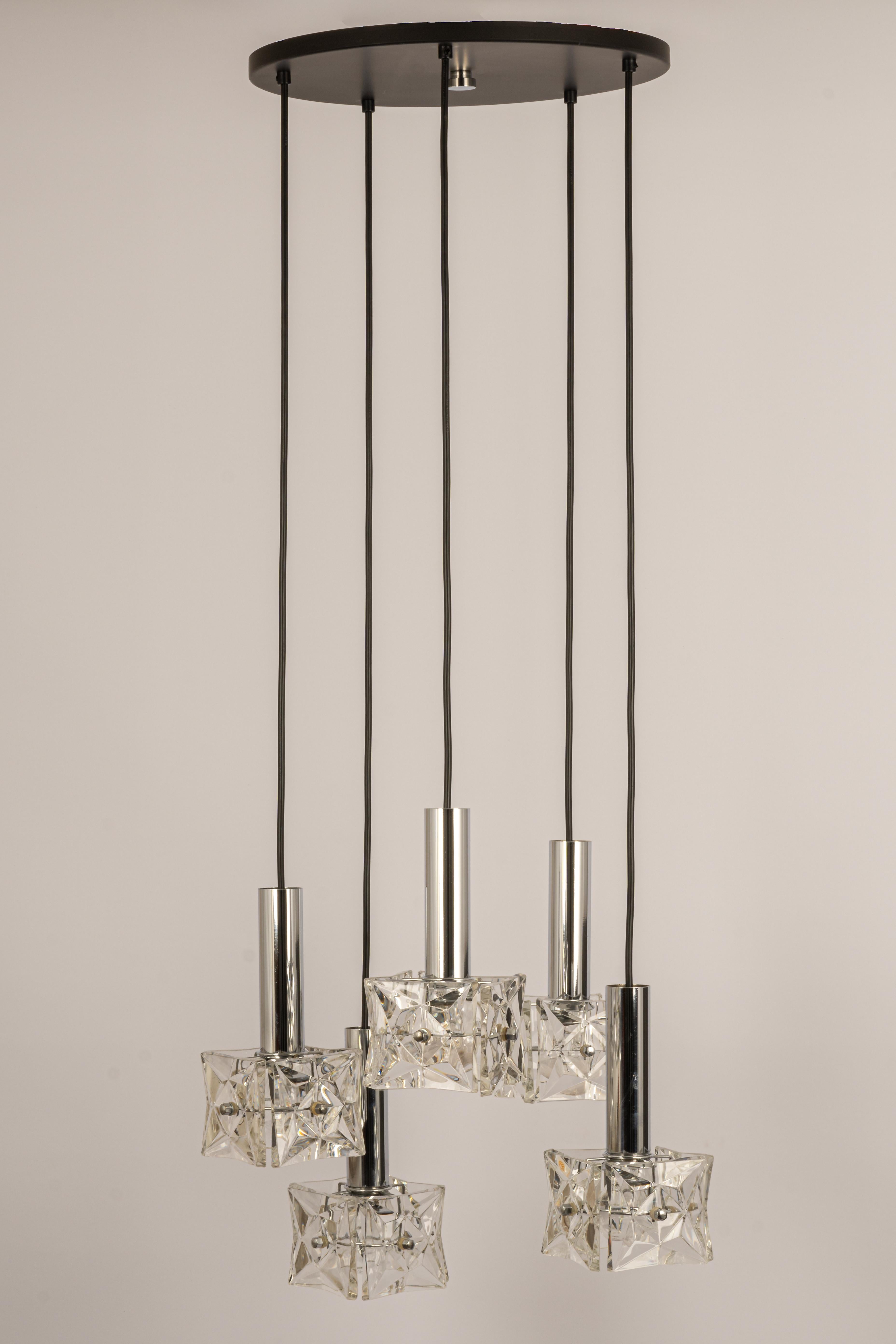 A stunning cascade chandelier made by Kinkeldey, Germany, manufactured in circa 1970-1979. A handmade and high-quality piece. Each frame of the pendants is made of chrome and has 4 facetted crystal glass elements.

Sockets: 5 x E27 standard