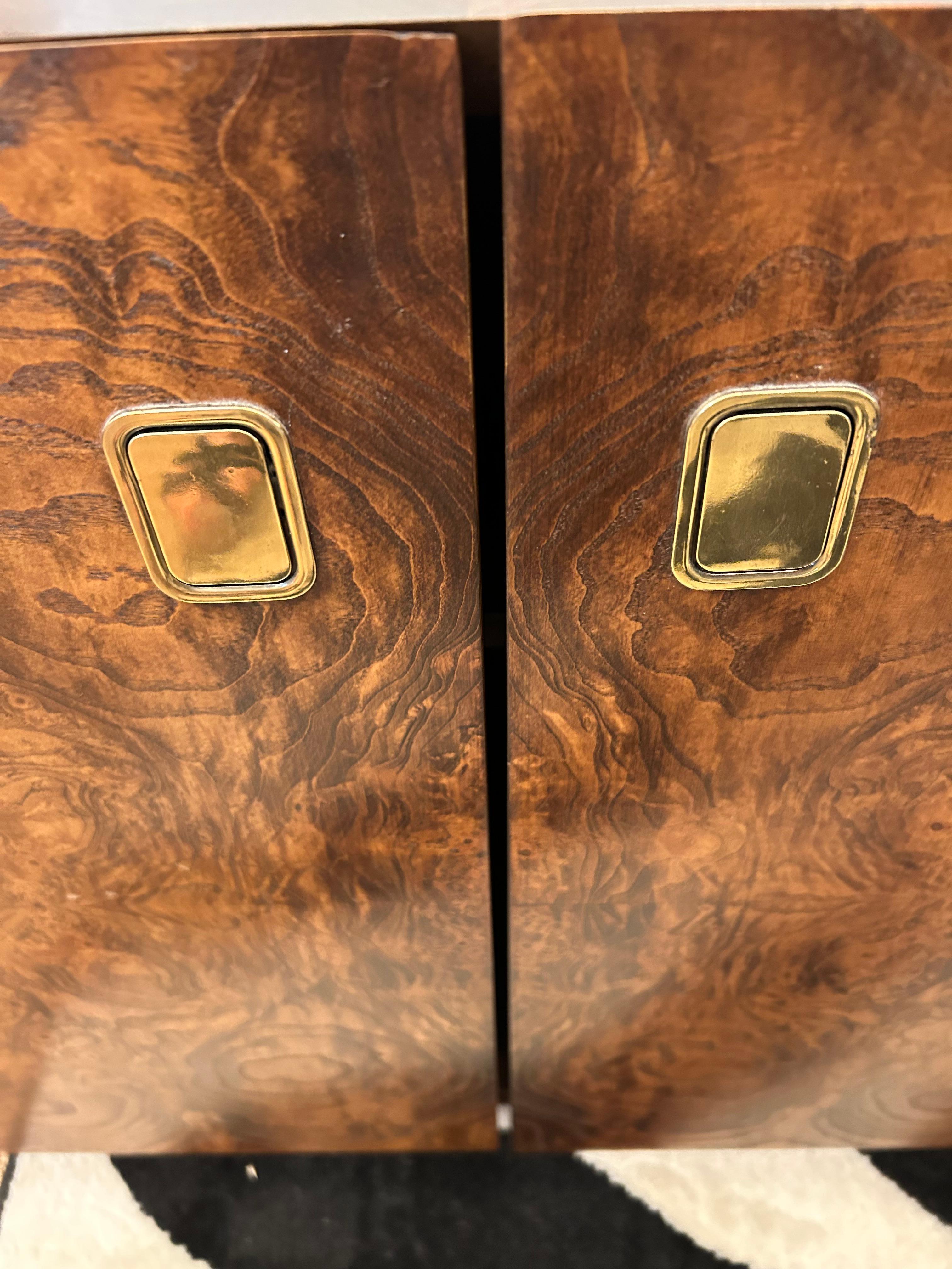 Stunning burl, brass and glass bar by Century Furniture having two doors with recessed hardware with inside storage.  Easily moved since the bar is on casters.
Removable glass has a slight defect along the back edge (not noticeable)
