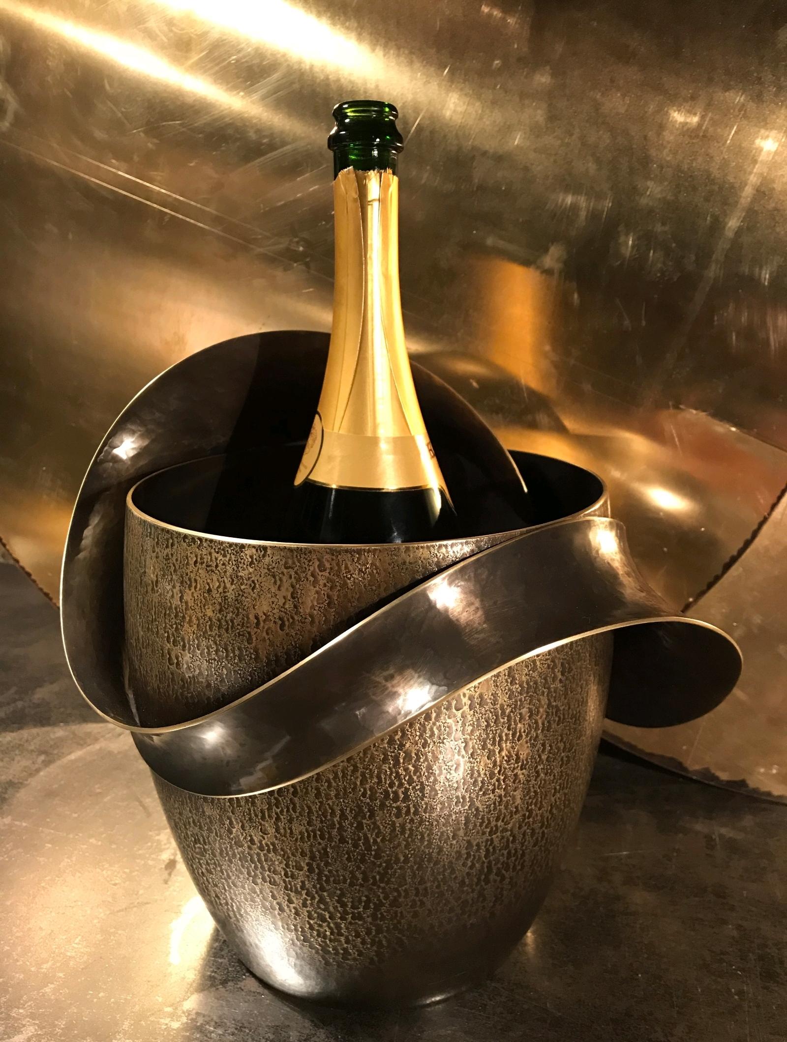 One of a kind gorgeous designer's Champagne and wine bucket cooler, in About the artist:
Polished brass.

About the artist: E.H.
Graduate in ceramic design and metal sculpture (2001,2003), he worked during two years with the sculptor Hervé