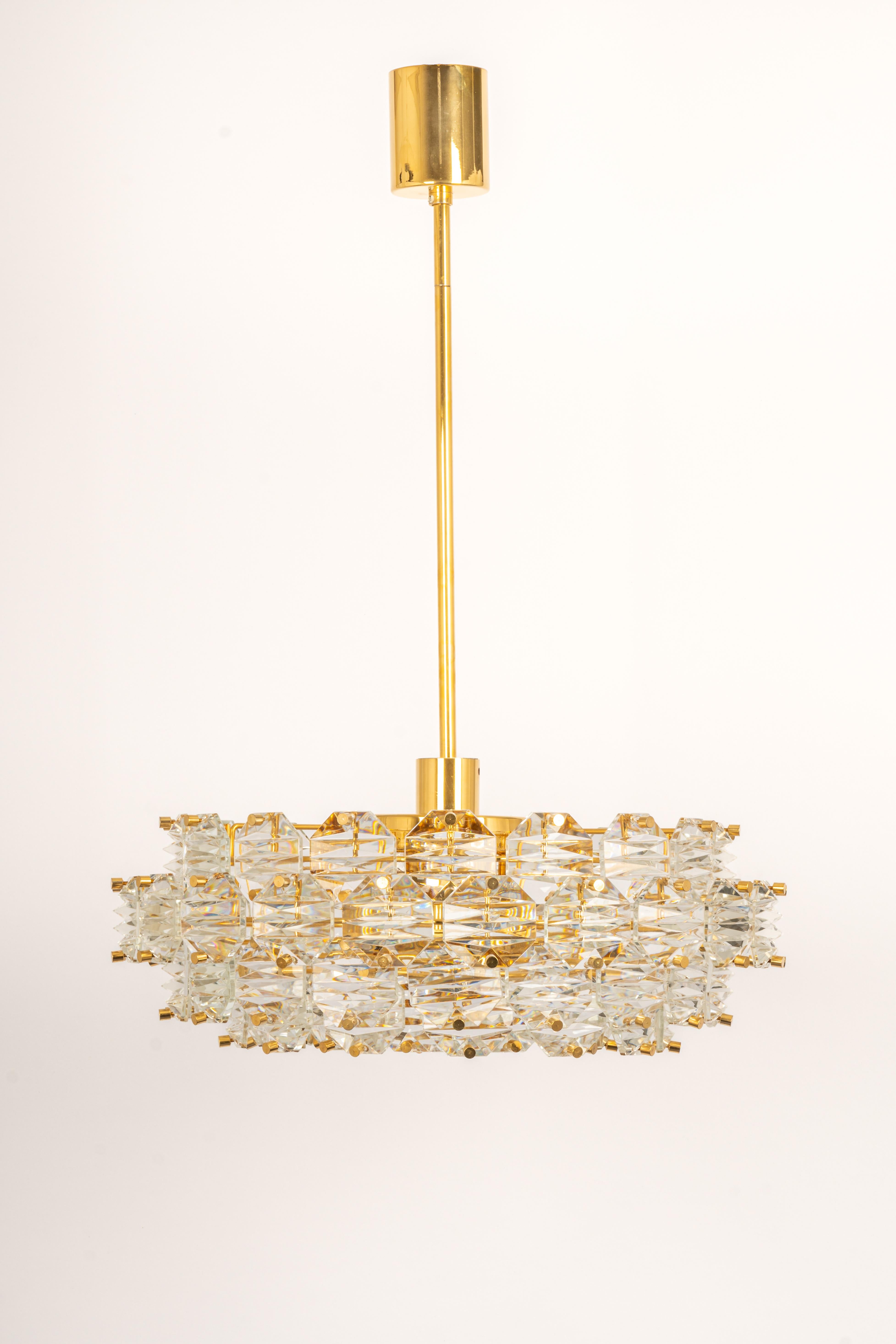 A stunning chandelier by Kinkeldey, Germany, manufactured in circa 1970-1979. A handmade and high-quality piece. The ceiling fixture and the frame are made of brass and have rings with lots of facetted crystal glass elements.

Heavy quality and in