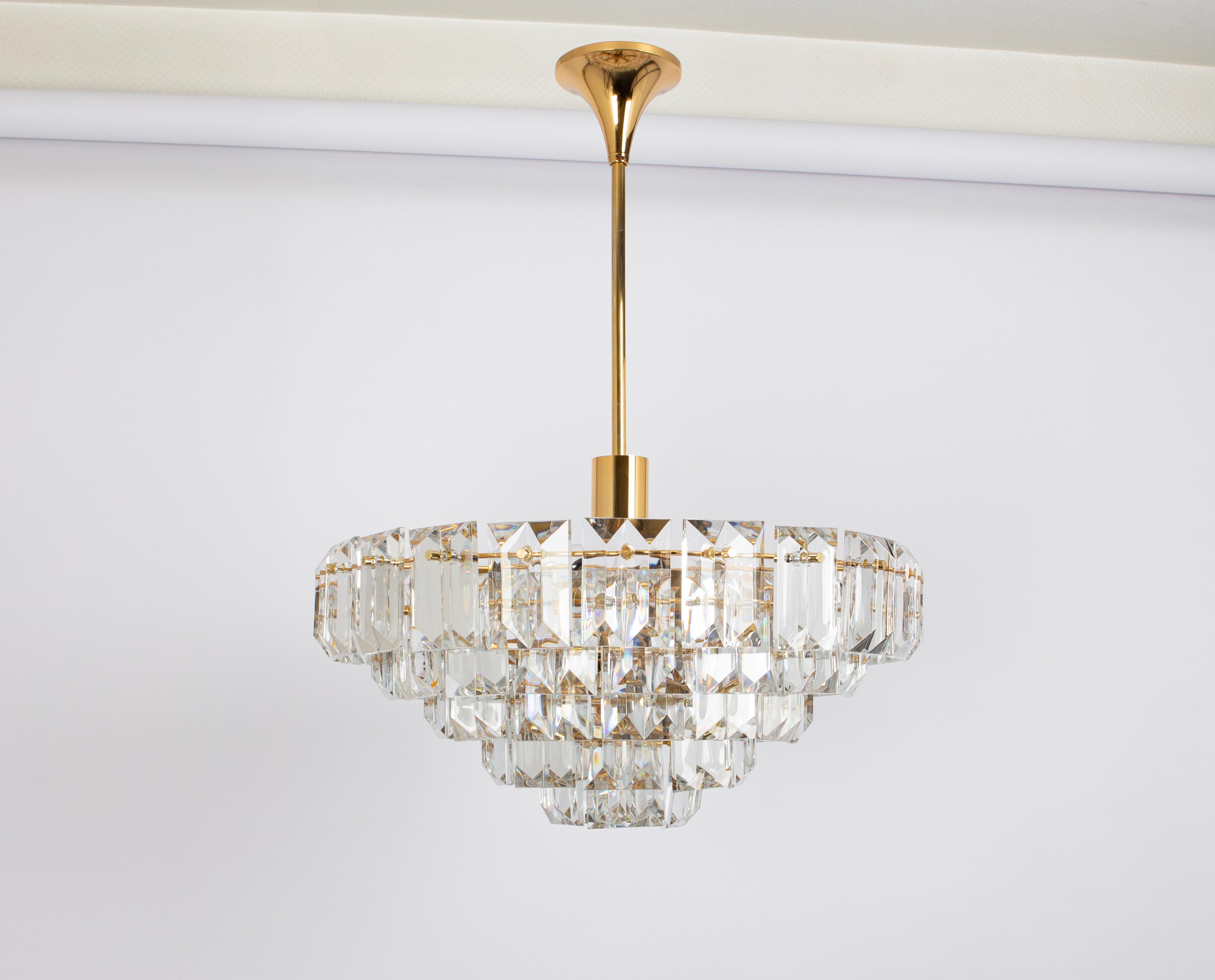 A stunning chandelier by Kinkeldey, Germany, manufactured in circa 1970-1979. A handmade and high quality piece. The ceiling fixture and the frame are made of brass and have rings with lots of facetted crystal glass elements.

Heavy quality and in