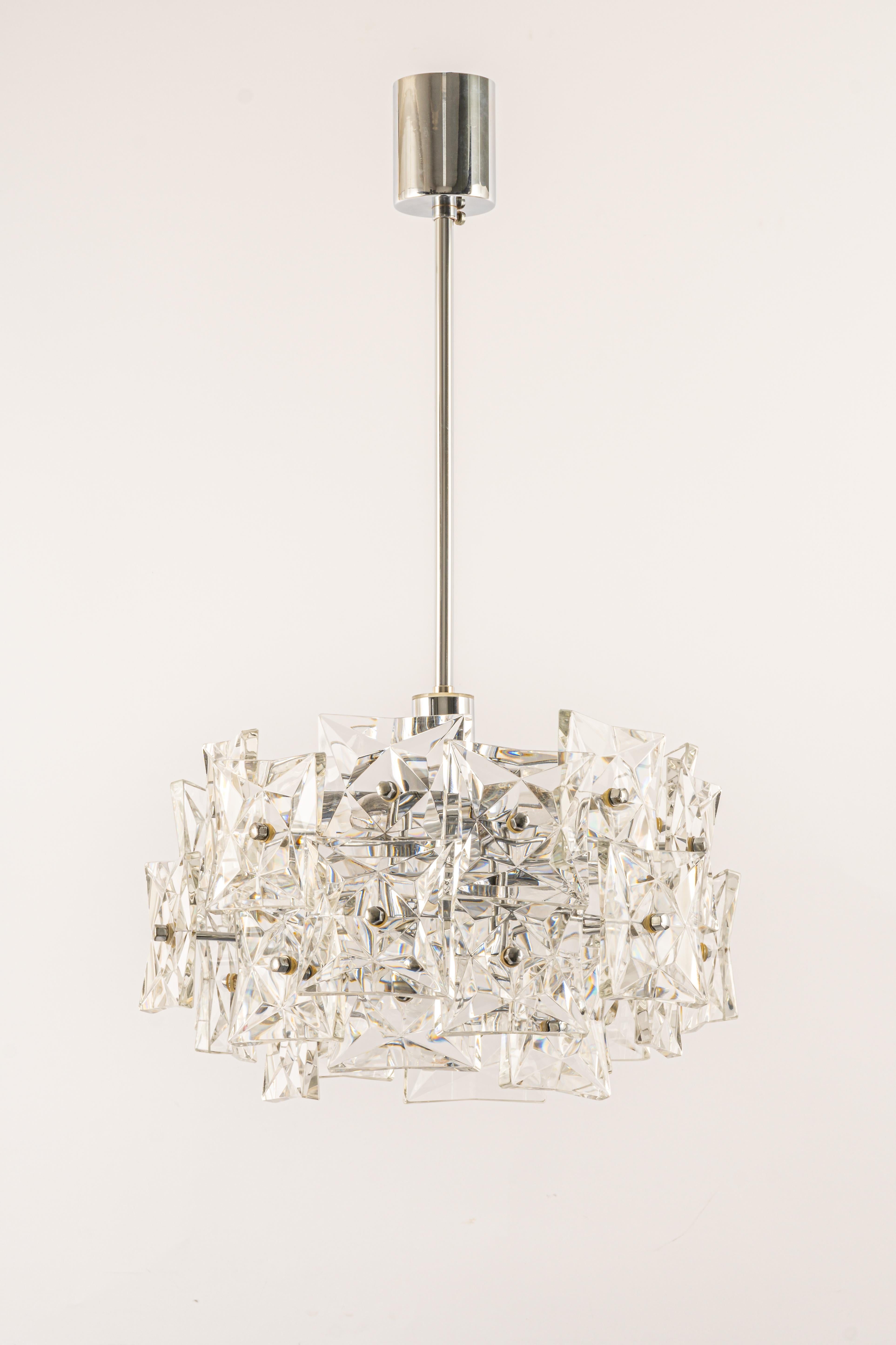 A stunning four-tier chandelier by Kinkeldey, Germany, was manufactured in circa 1970-1979. A handmade and high quality piece. The ceiling fixture is made of chrome and have four rings with lots of facetted crystal glass elements.

Sockets: 6 x E14