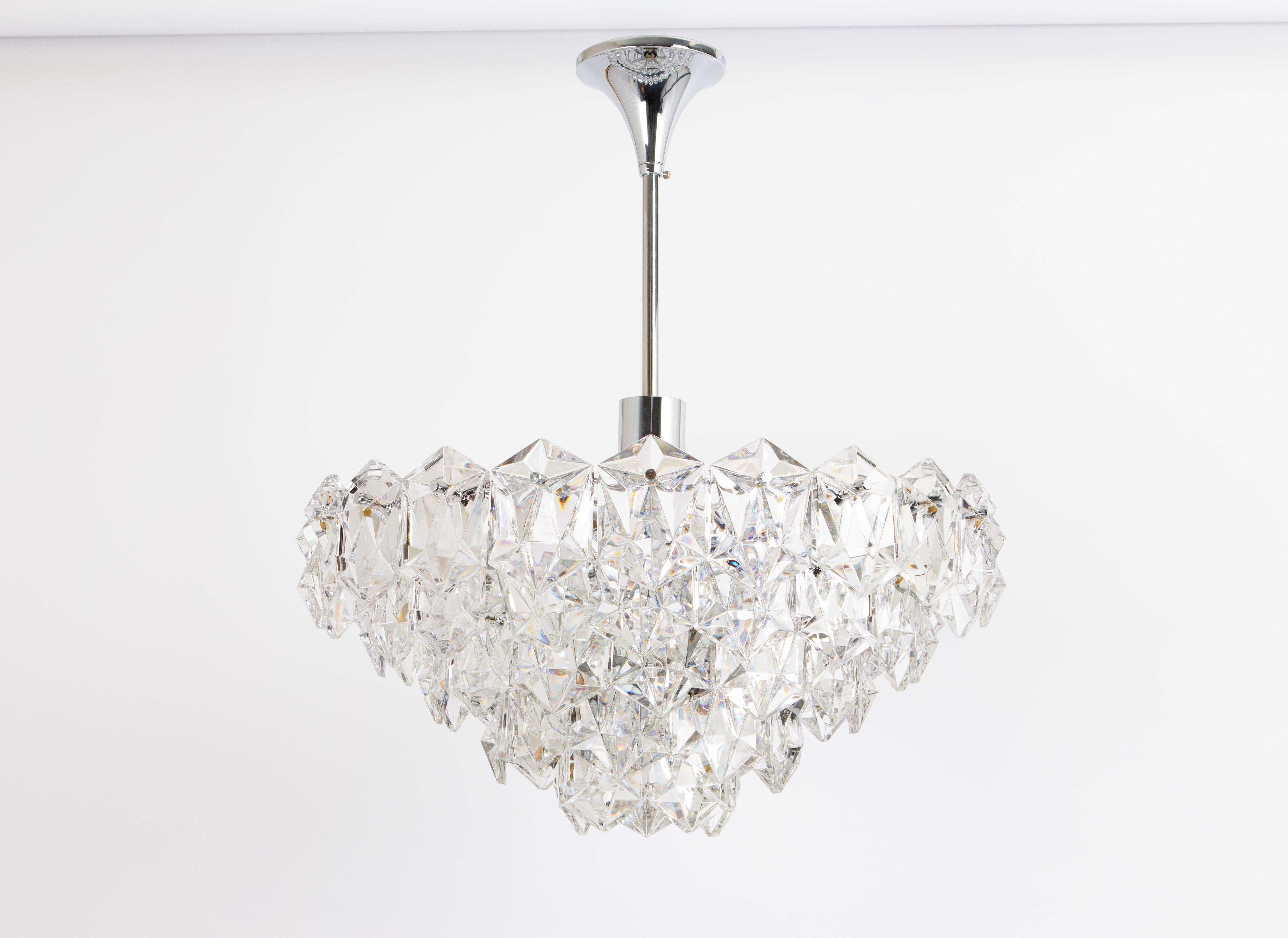A stunning chandelier by Kinkeldey, Germany, manufactured in circa 1970-1979. A handmade and high-quality piece. The ceiling fixture and the frame are made of metal and have rings with lots of facetted crystal glass elements.

Good condition.