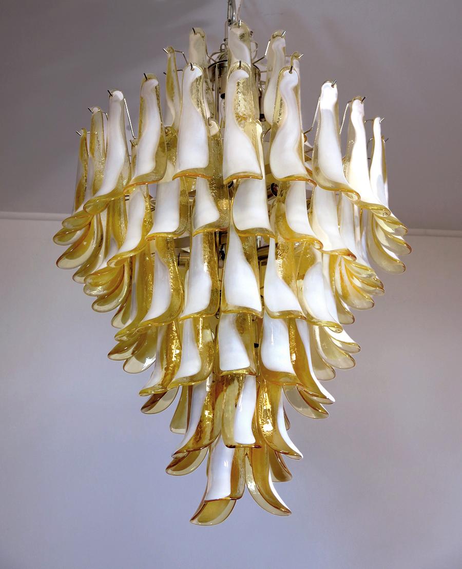 Handblown glass chandelier, composed of 85 curved, caramel lattimo glass pieces, which are arranged on 7 tiers, suspended from a nickel metal structure.
Period:late xx century
Dimensions: 47,25 inches (120 cm) height without chain; 31,50 inches