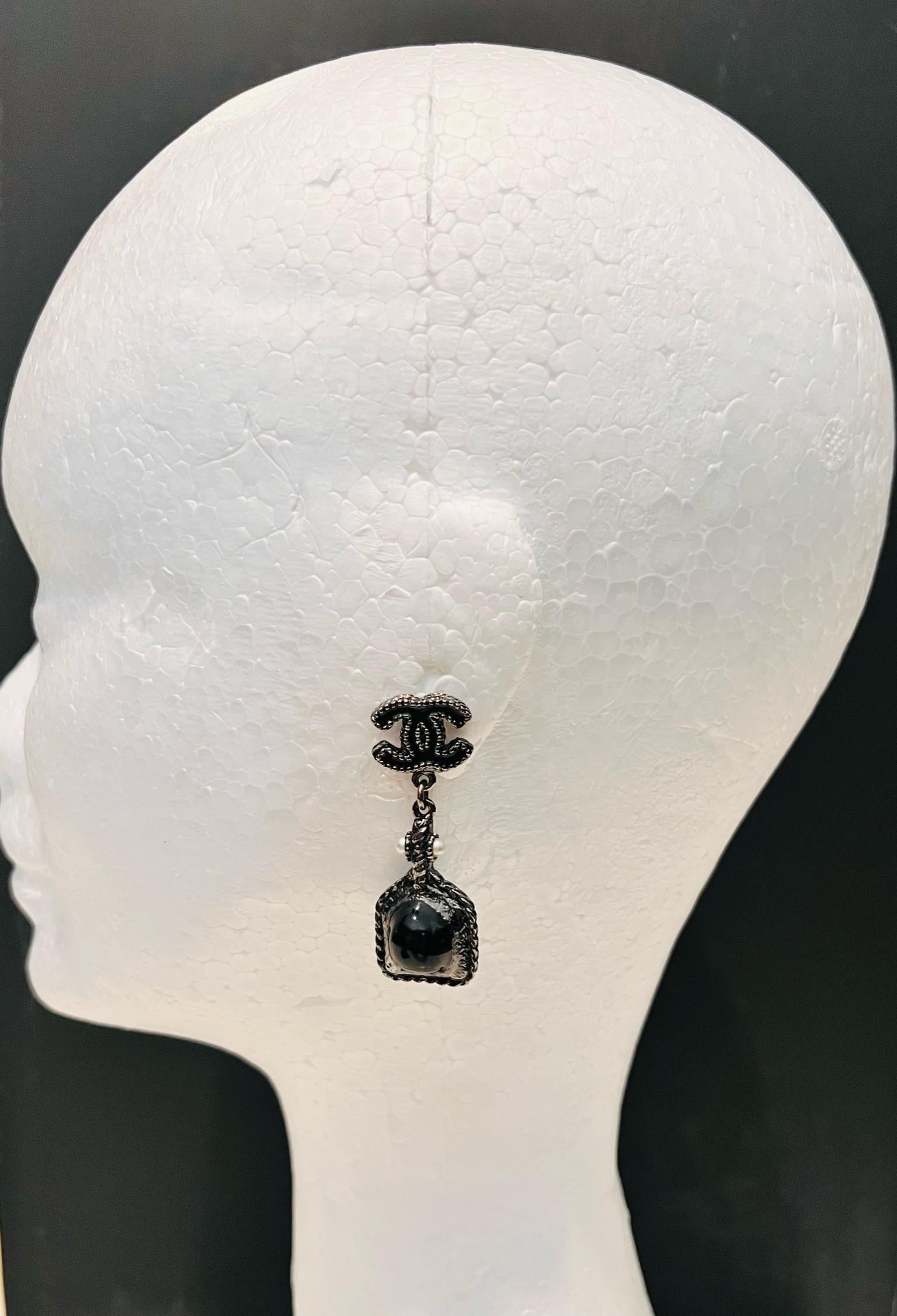 Stunning CHANEL Black and Pearl drop earrings. Features iconic CC logo.

Comes with original box. 
