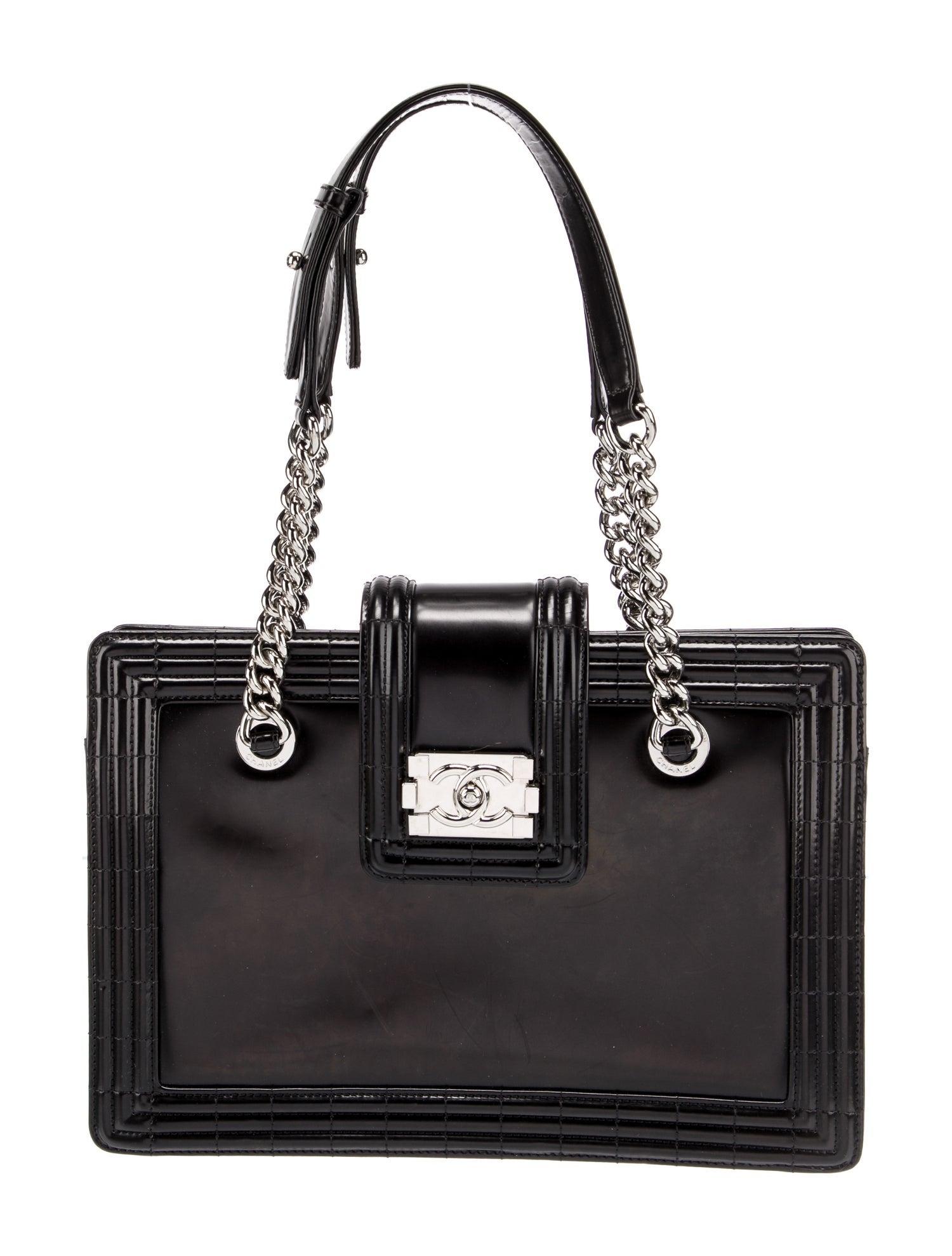 Stunning Chanel Leather Reverso Boy Tote w/ Interlocking CC Logo Closure

Black Glazed Goatskin
Silver Hardware
Chain Link Straps
Flat Leather Handles
Grosgrain Lining & Four Interior Pockets
Includes Authenticity Card
2012
Shoulder Strap Drop: