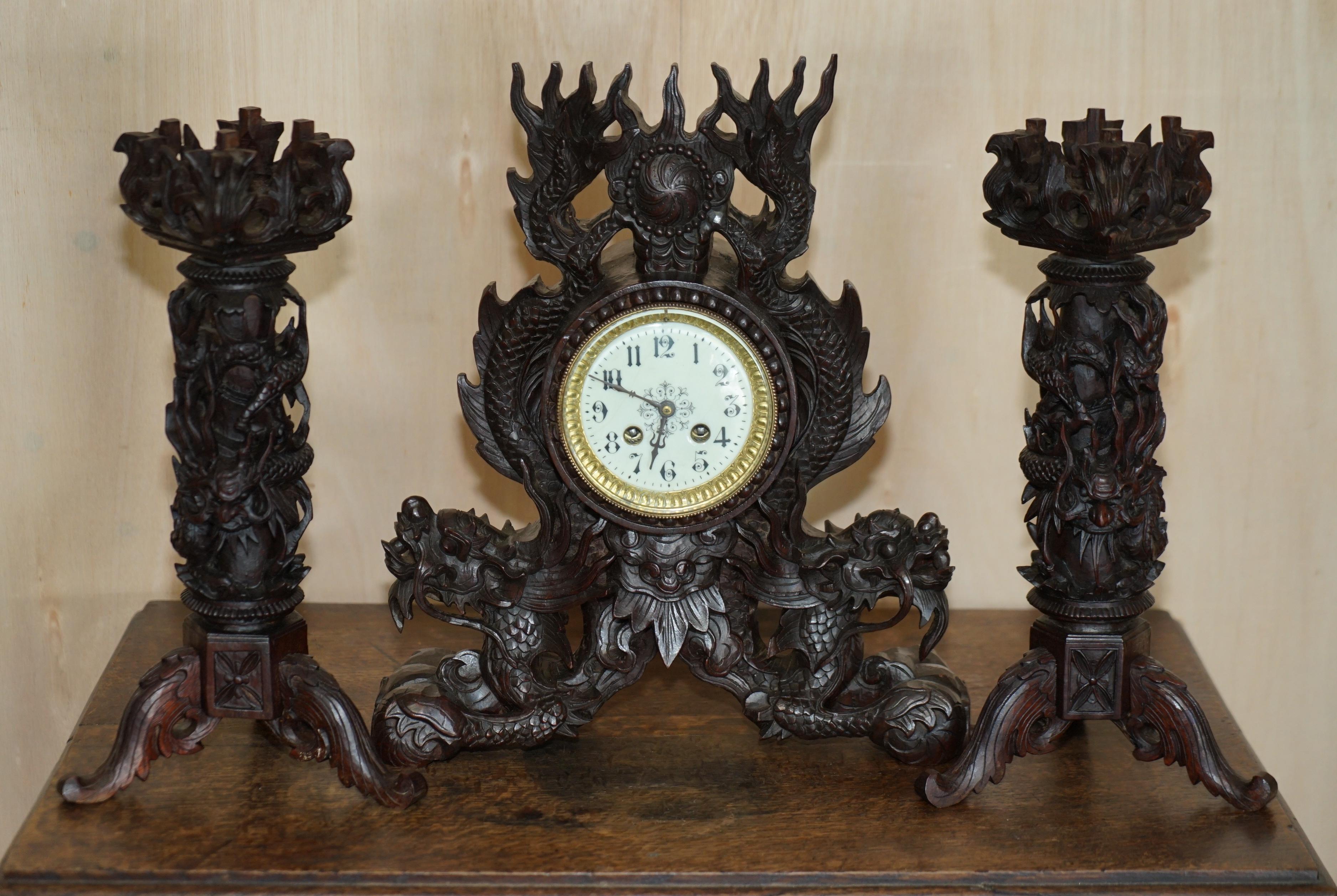 Royal House Antiques

Royal House Antiques is delighted to offer for sale this stunning circa 1880-1920 Chinese Export hand carved dragon mantle clock with matching candlesticks

A good looking and expertly carved suite, I have not seen another