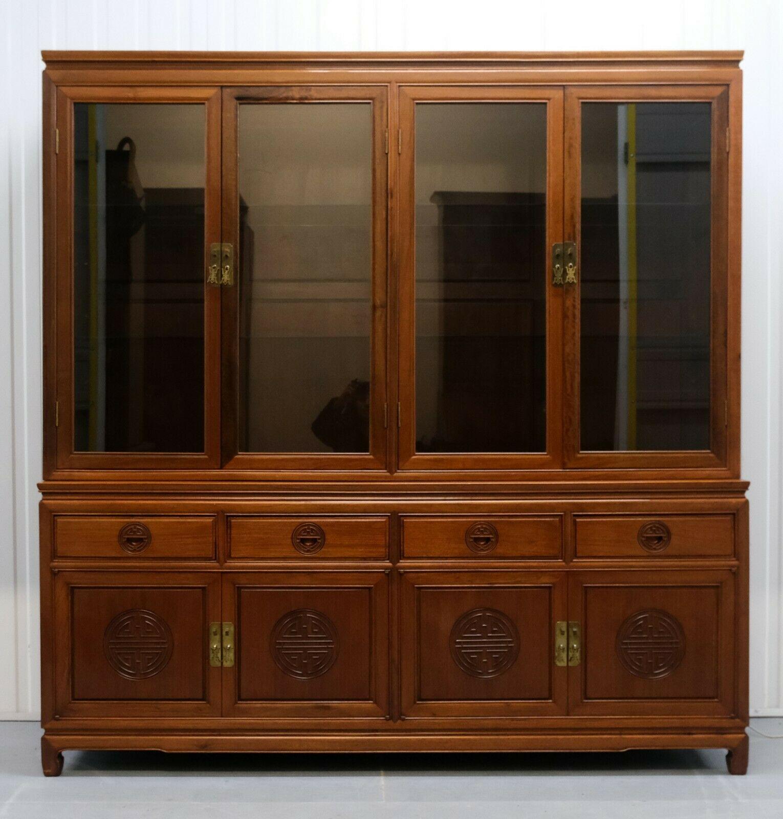 We are delighted to offer for sale this stunning and solid hardwood Chinese cupboard/cabinet with lights.

This sturdy and solid cabinet has adjustable glass shelves on top and brass handles on the doors. Each carved panel was hand-made with long