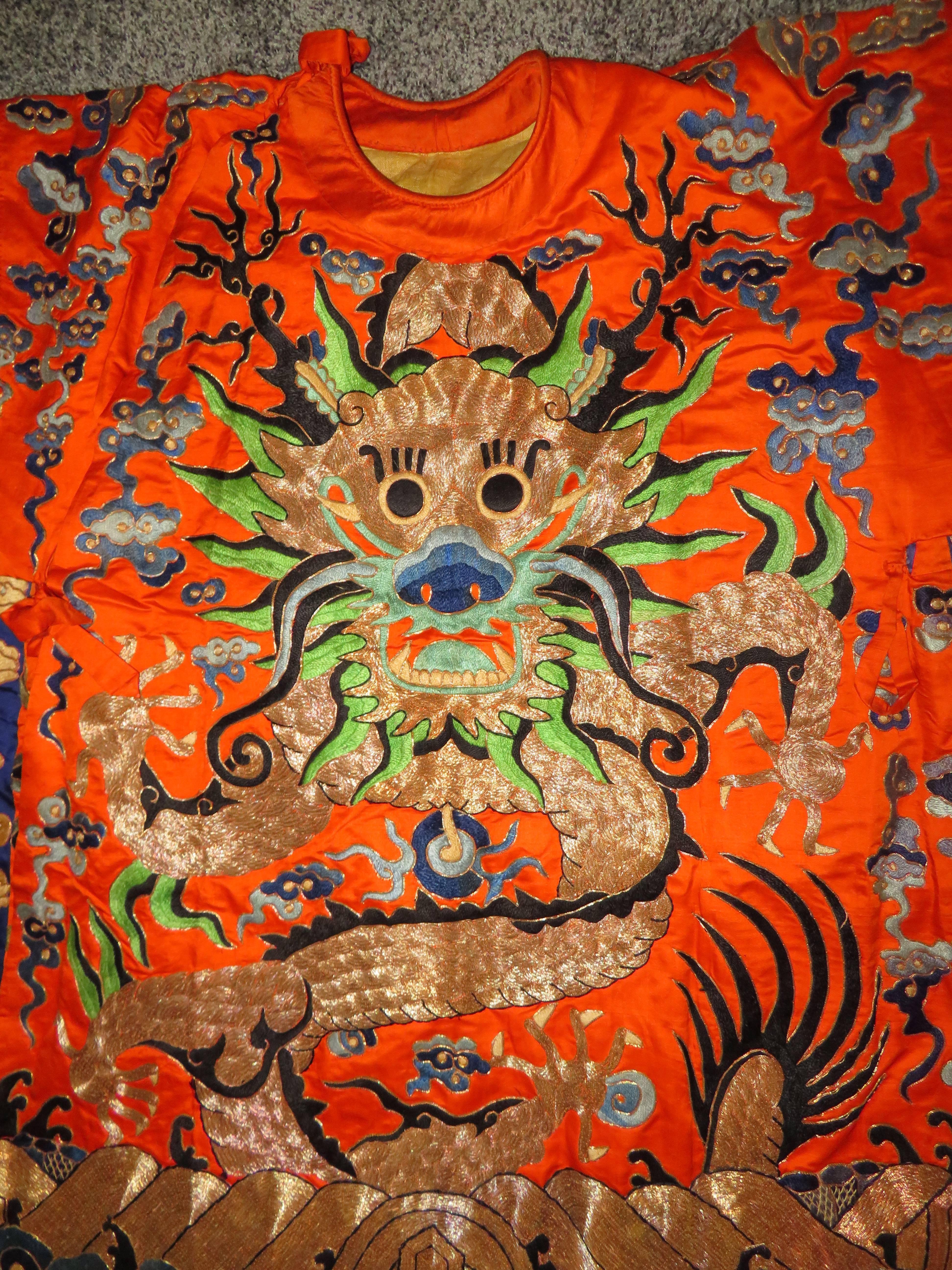 Stunning Chinese gold thread embroidered dragon ceremonial kimono robe, circa early 20th century. We just love the animated gold dragon embroidered on both sides along with the Hermes orange silk background.