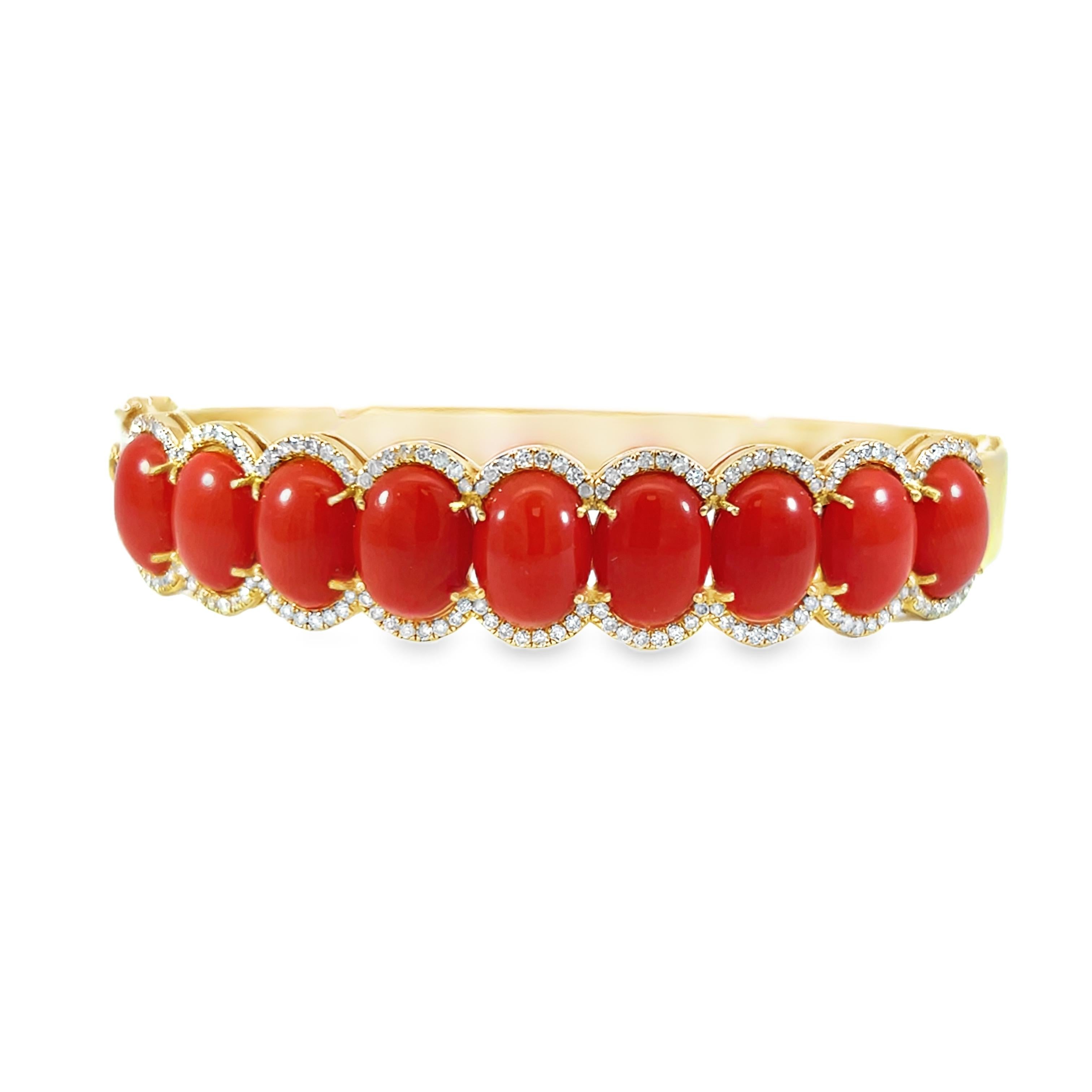 This gorgeous 10.81-carat oval-shaped natural coral and 0.73-carat diamond bangle is the ideal combination of sophistication and elegance. Every coral is beautifully covered with diamonds. Featuring a series of bright coral stones set against a