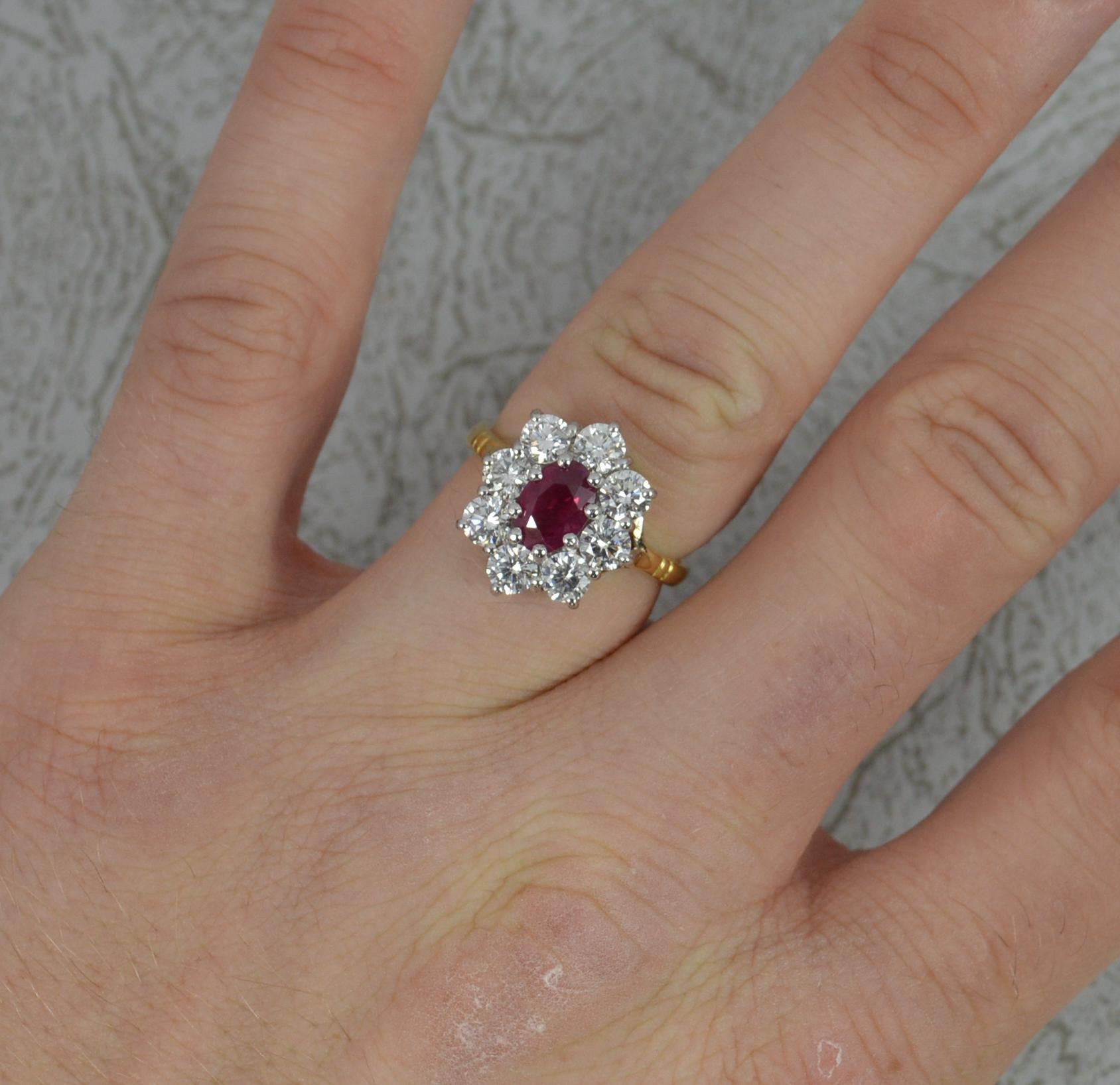 A stunning ladies cluster ring.
Modelled in 18 carat yellow gold with a white gold head.
Set with a single oval shaped ruby to centre, 5mm x 7.2mm approx. Surrounding are eight natural round brilliant cut diamonds.
Total diamond carat weight of 1.60