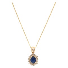 Stunning Classic Sapphire 
.25 CTW Diamond Halo Pendant Necklace in 14K