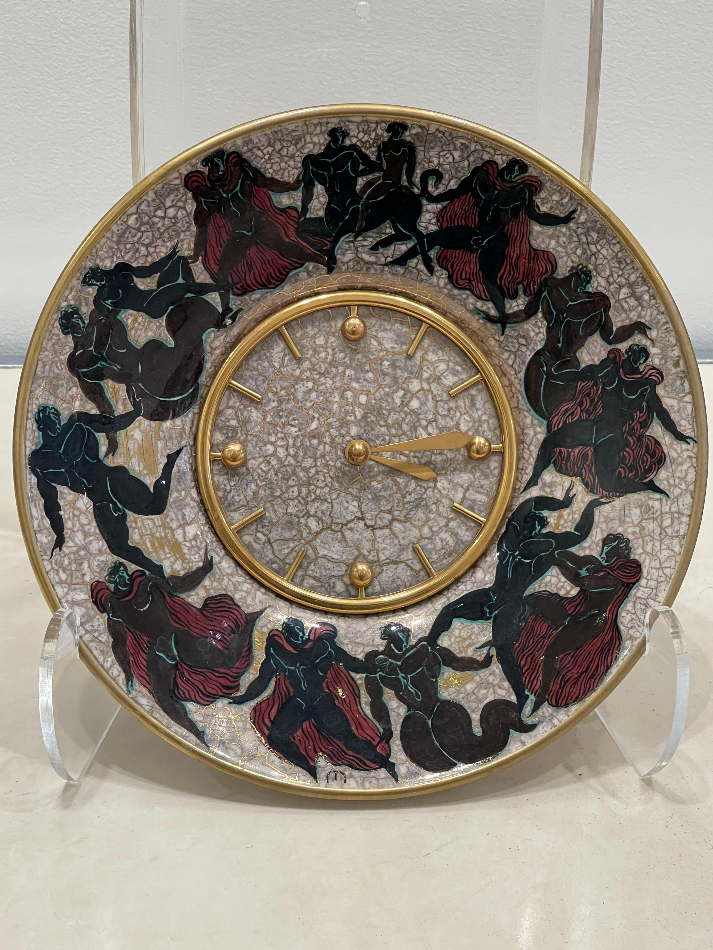 Stunning clock by famous  clockmaker Hour Lavigne and ceramist Jean Léon Mayodon (1893-1967)

This clock is made of a central  clock by Hour Lavigne mounted on a plate realized by J.L. Mayodon. This clock is designed to be mounted on a wall but can