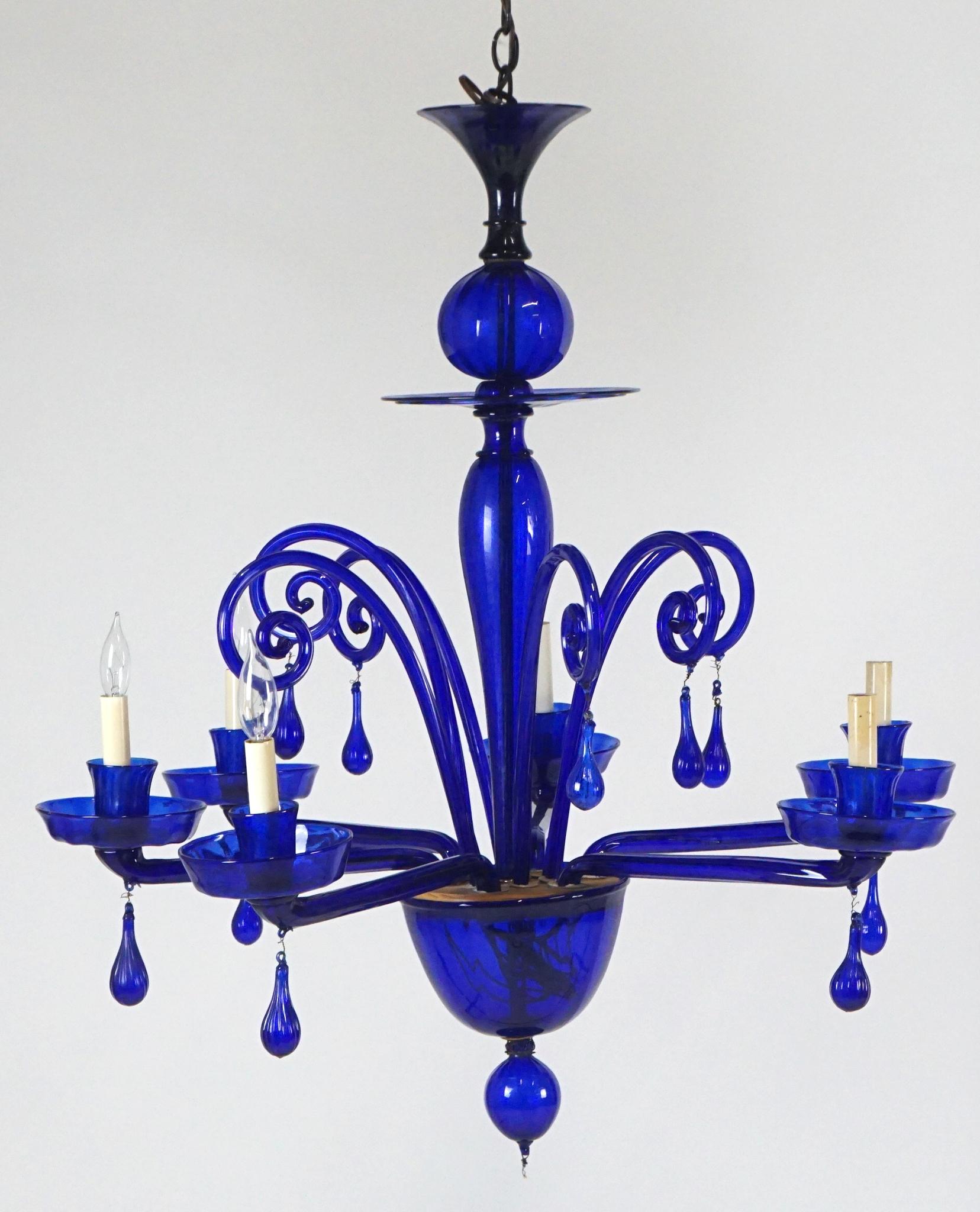 Absolutely stunning cobalt blue midcentury Murano cobalt blue chandelier. This piece is in very good condition. Appears to be one missing piece at the very bottom of the chandelier. Could be replaced but looks fine without,
circa 1960s.