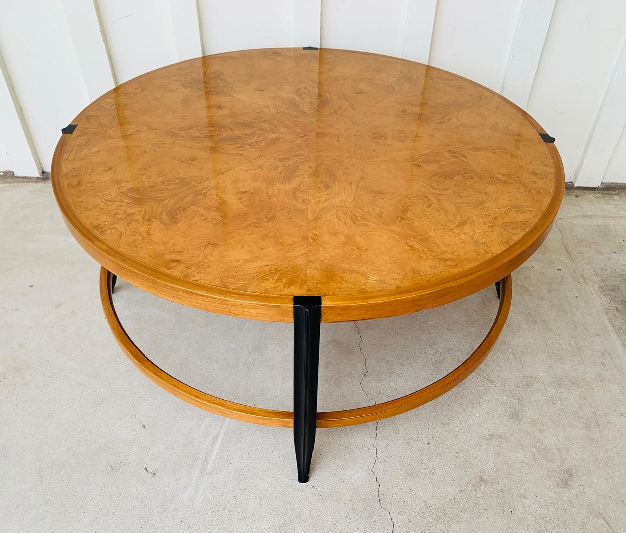 Stunning coffee table with maple burl wood top and black lacquered legs.

The table has a second self which could accommodate a glass piece for extra storage space.

Measurements:
38 inches in diameter x 18 inches high x 6 inches high to