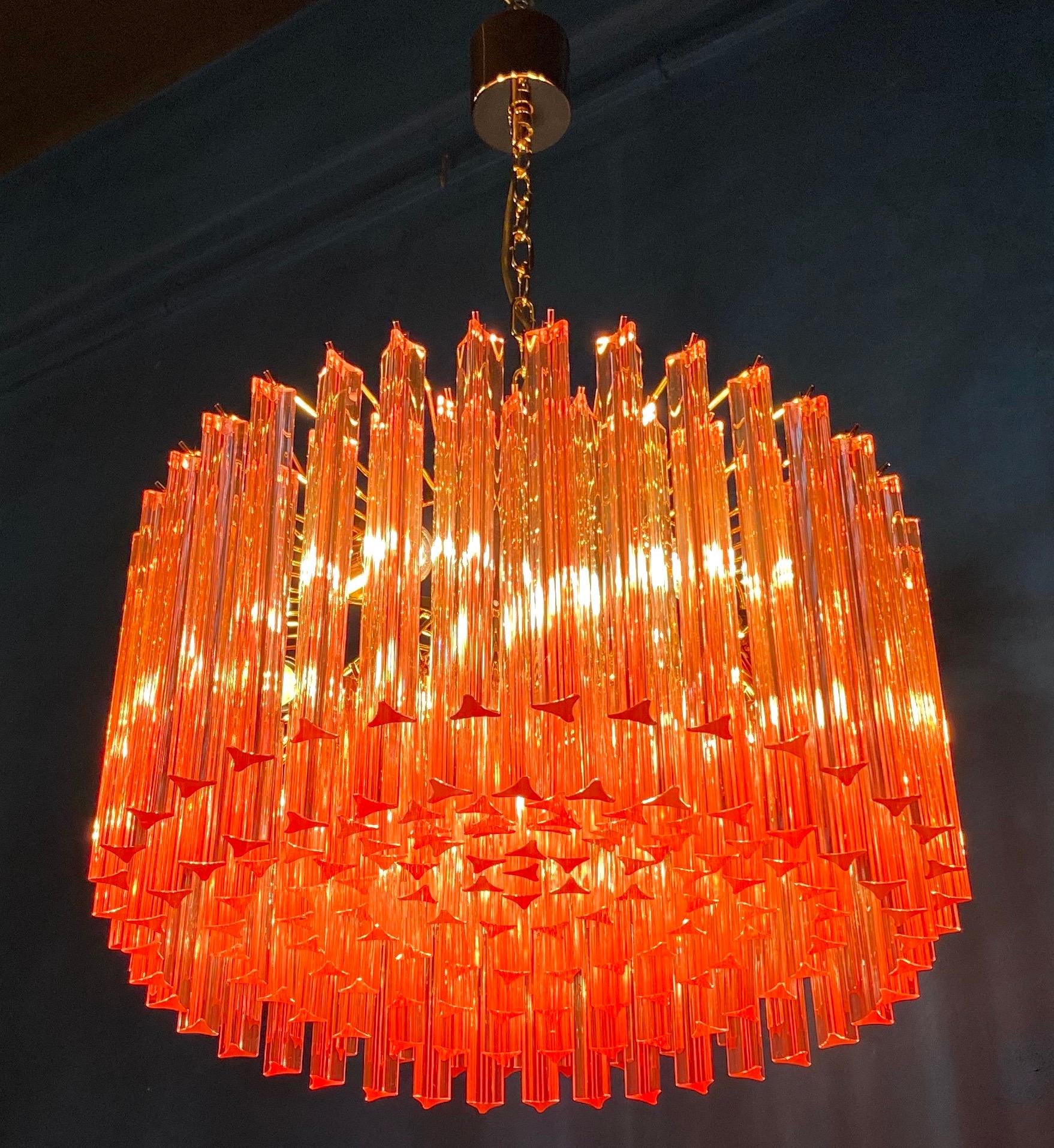 Fabulous Murano glass chandelier with stunning  coral color triedri on brass frame.
Available a pair.
Dimensions: 43.30 inches (110 cm) height with chain; 13 inches (33 cm) height without chain; 23.5 inches (60 cm) diameter.
Light bulbs: 6 light