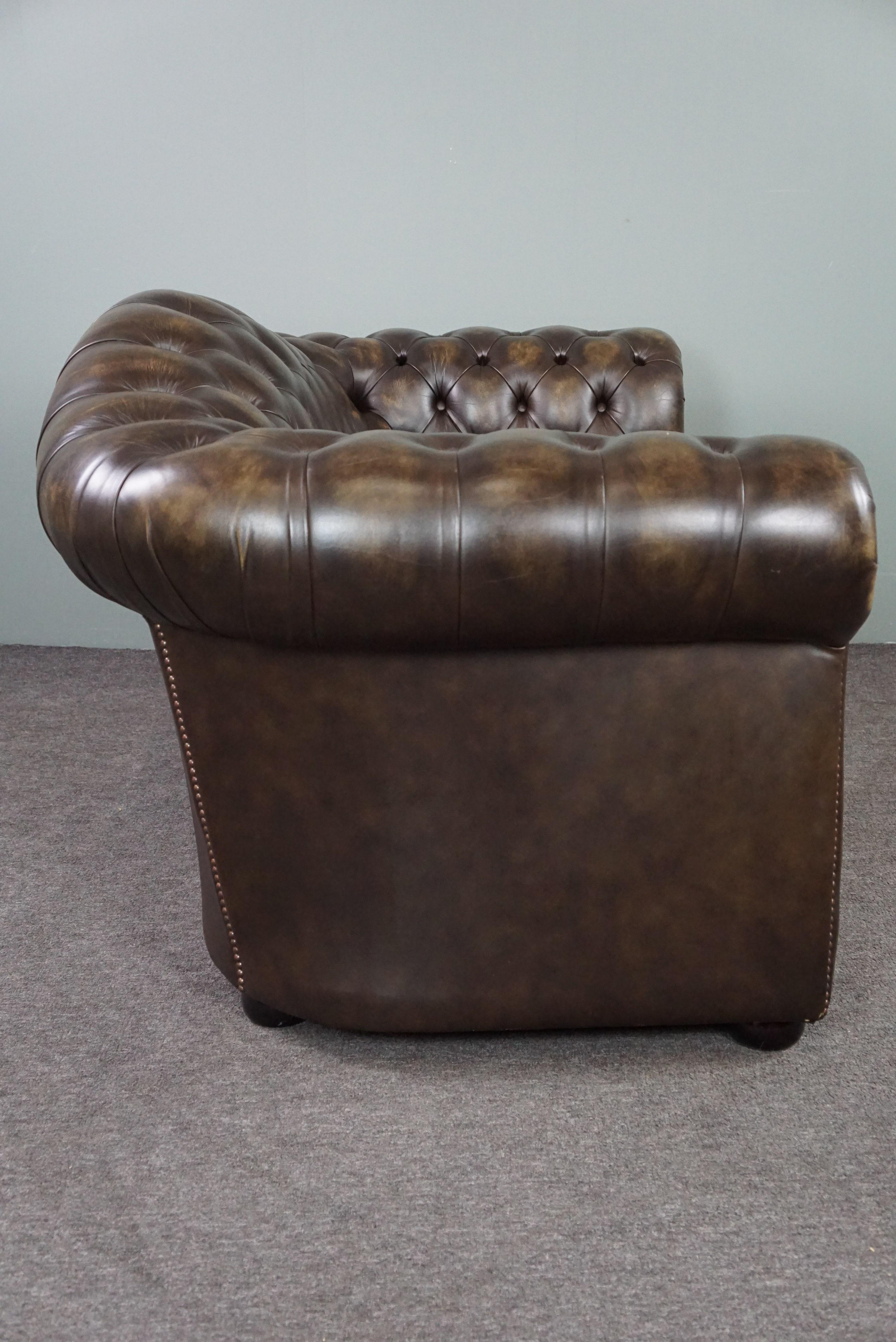 Offered is this almost new cowhide Chesterfield sofa, 2 seater.

This cowhide Chesterfield sofa is a great example because of its design, color and appearance. The sofa has a shapely padded back and armrests that are beautifully finished with