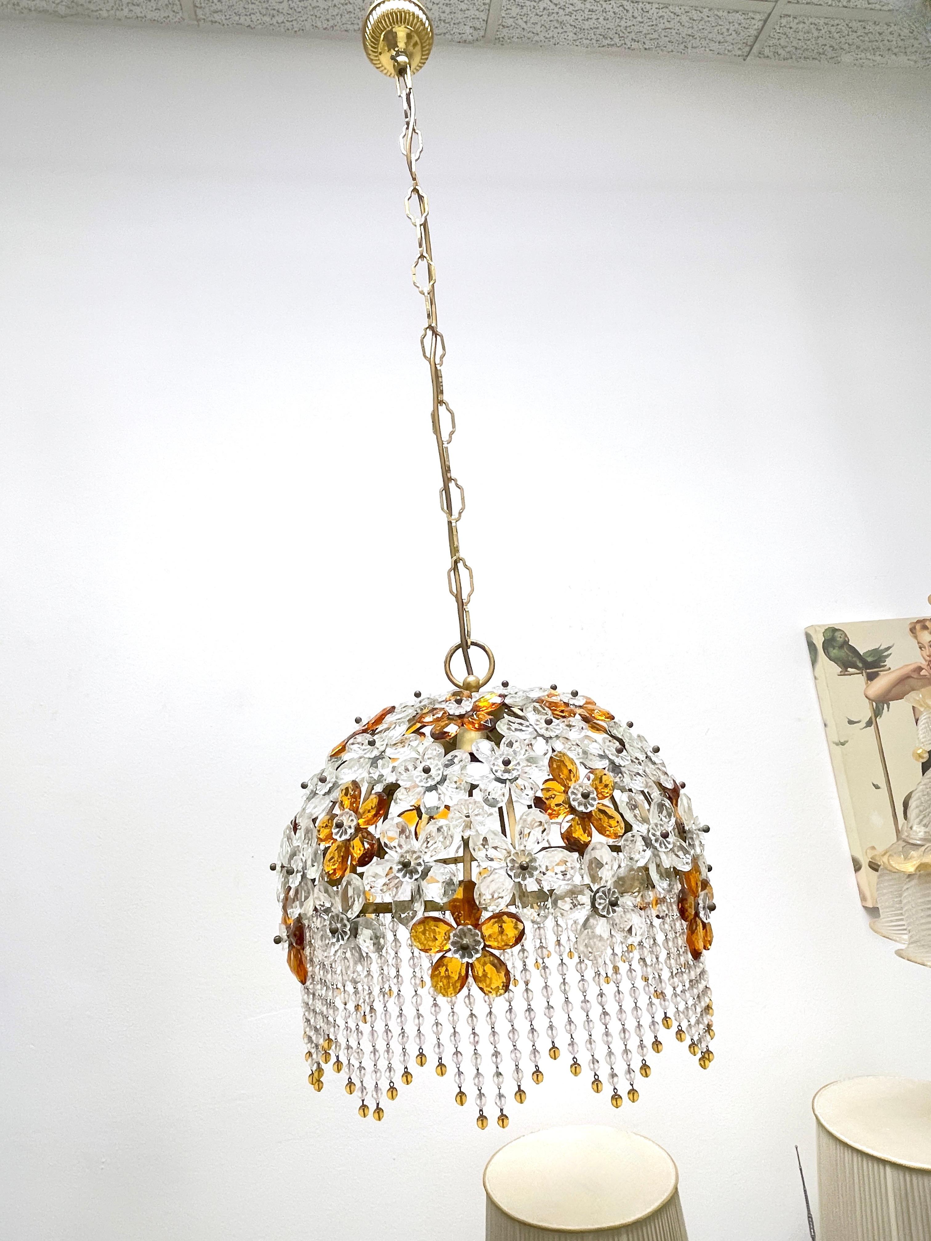 Beautiful chandelier made by Banci, Firenze, Italy. This light fixture is made of metal and lovely elements of glass in the style of leaf's and flowers. Gorgeous lamp with crystal glass, in very good vintage condition. It is a mix of amber and clear
