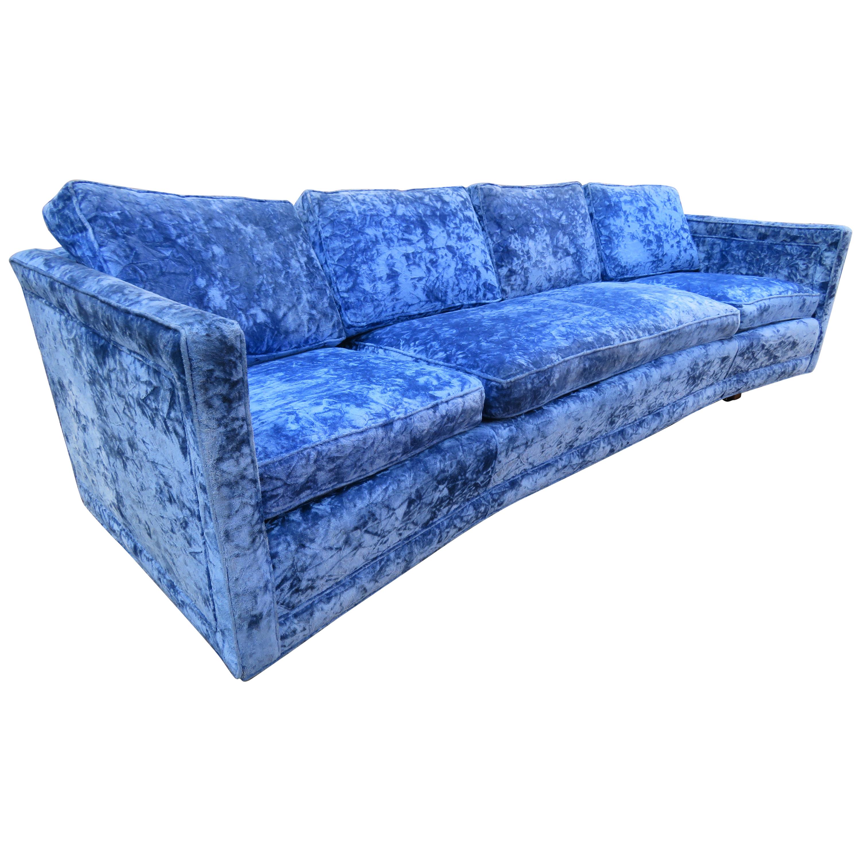 Stunning Erwin Lambeth curved back sled leg sofa. This sofa was reupholstered long ago in this wonderful sapphire blue crushed velvet and still looks great-only minor signs of age. We love the thick heavy solid walnut sled legs-handsome indeed! This