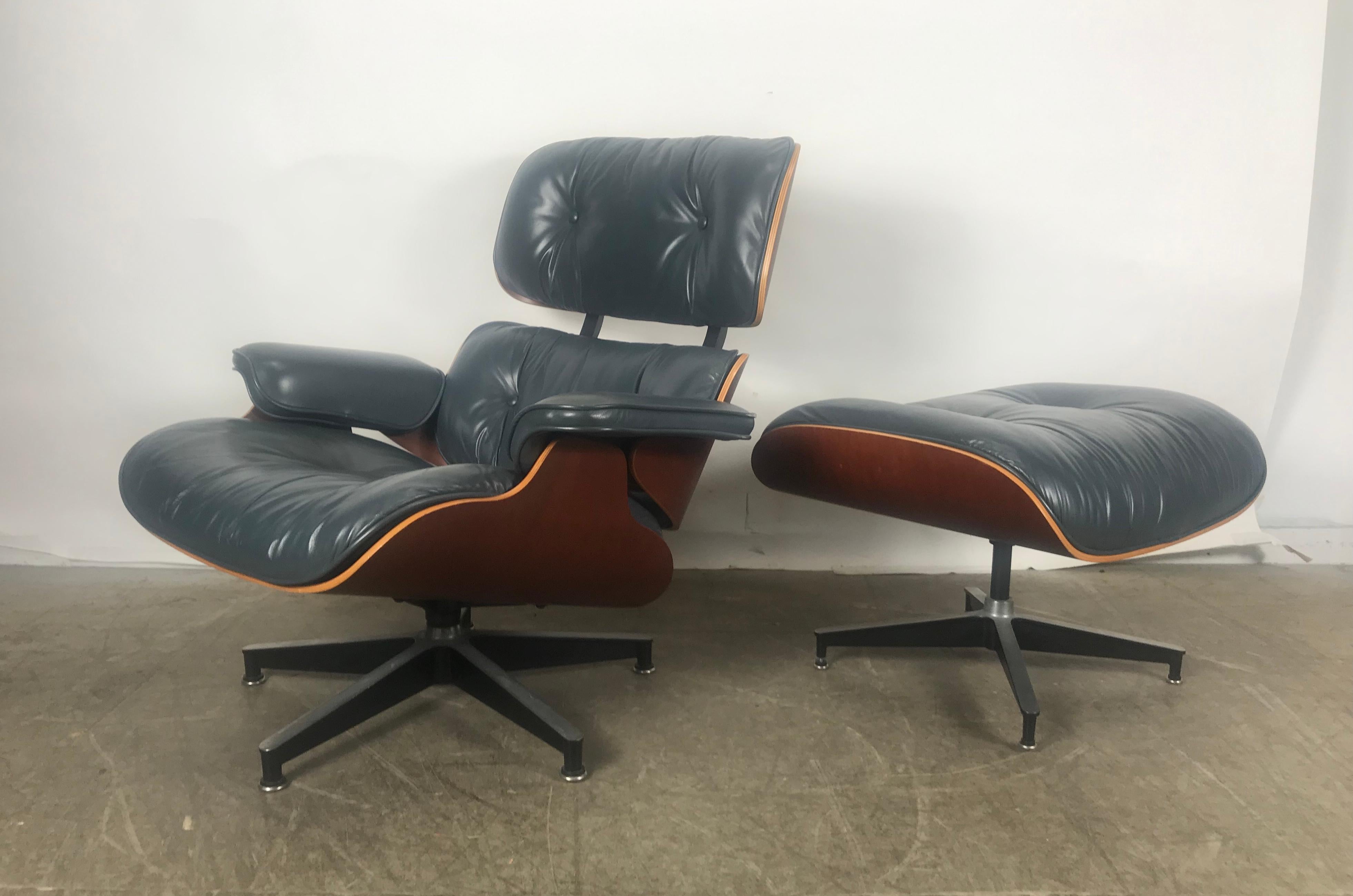 Stunning 670 and 671 lounge chair and ottoman by Charles and Ray Eames manufactured by Herman Miller, custom ordered slate blue leather, amazing color, cherry plywood shell, nice original condition, minor wear to buttons and back of one arm,