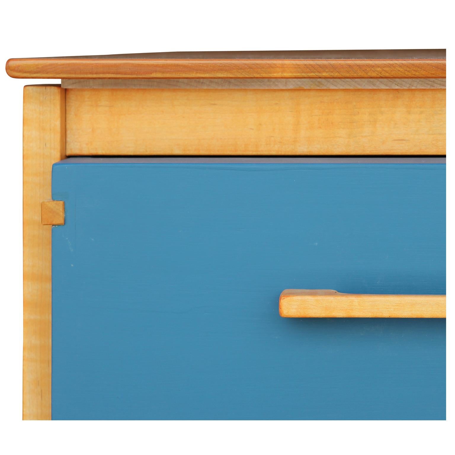 Stunning custom Scandinavian modern small chest by norm stoeker. The three exposed Egyptian blue drawers are made with master craftsmanship surrounded by satin maple. The dovetailed construction adds interest from all angles. Stunning in person,