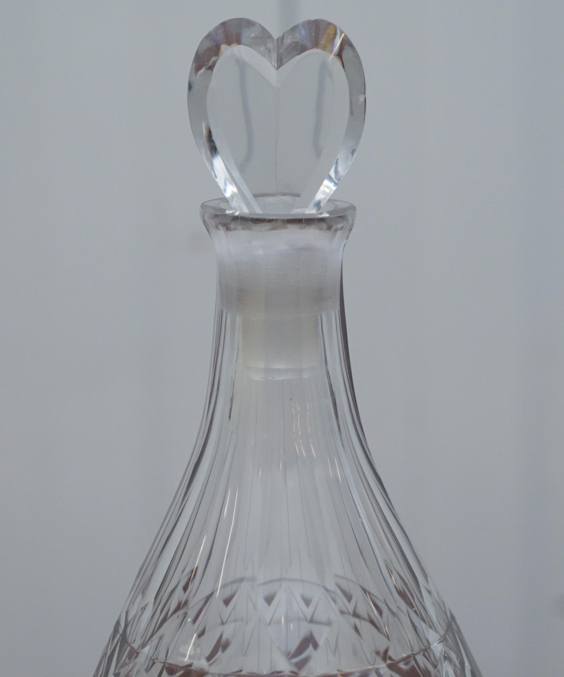 We are delighted to offer for sale this lovely handblown cut glass crystal decanter with heart-shaped finial stopper.

I also have a set of four Asprey London pinch decanters for sale each with sterling silver collars and sterling silver tags and