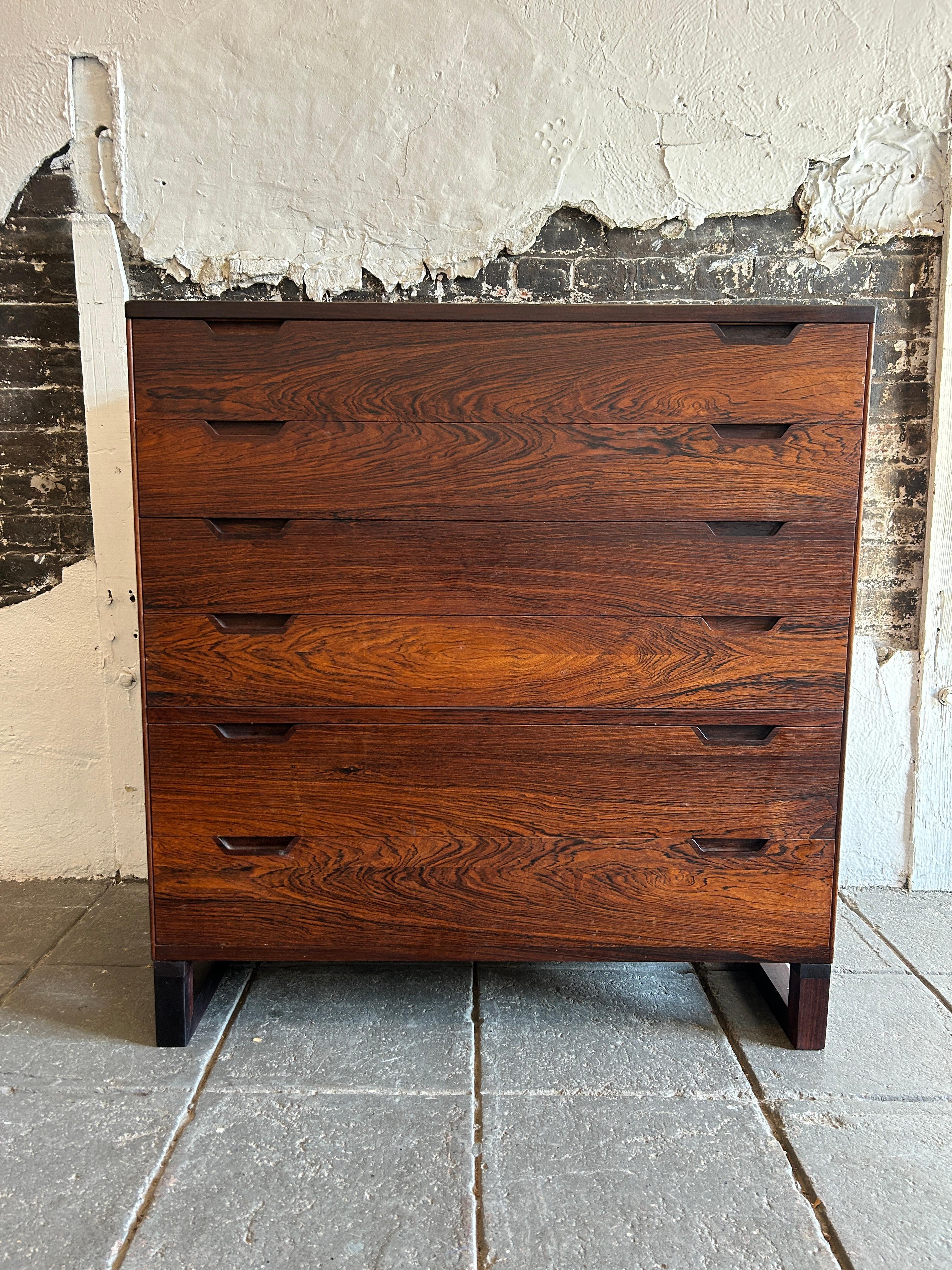 Stunning danish modern Svend Langkilde Rosewood 6 drawer tall dresser. Really beautiful Scandinavian woodworking on this 6 drawer dresser. The rosewood grain is really beautiful great design all around. Sits on solid rosewood base. Made in Denmark.