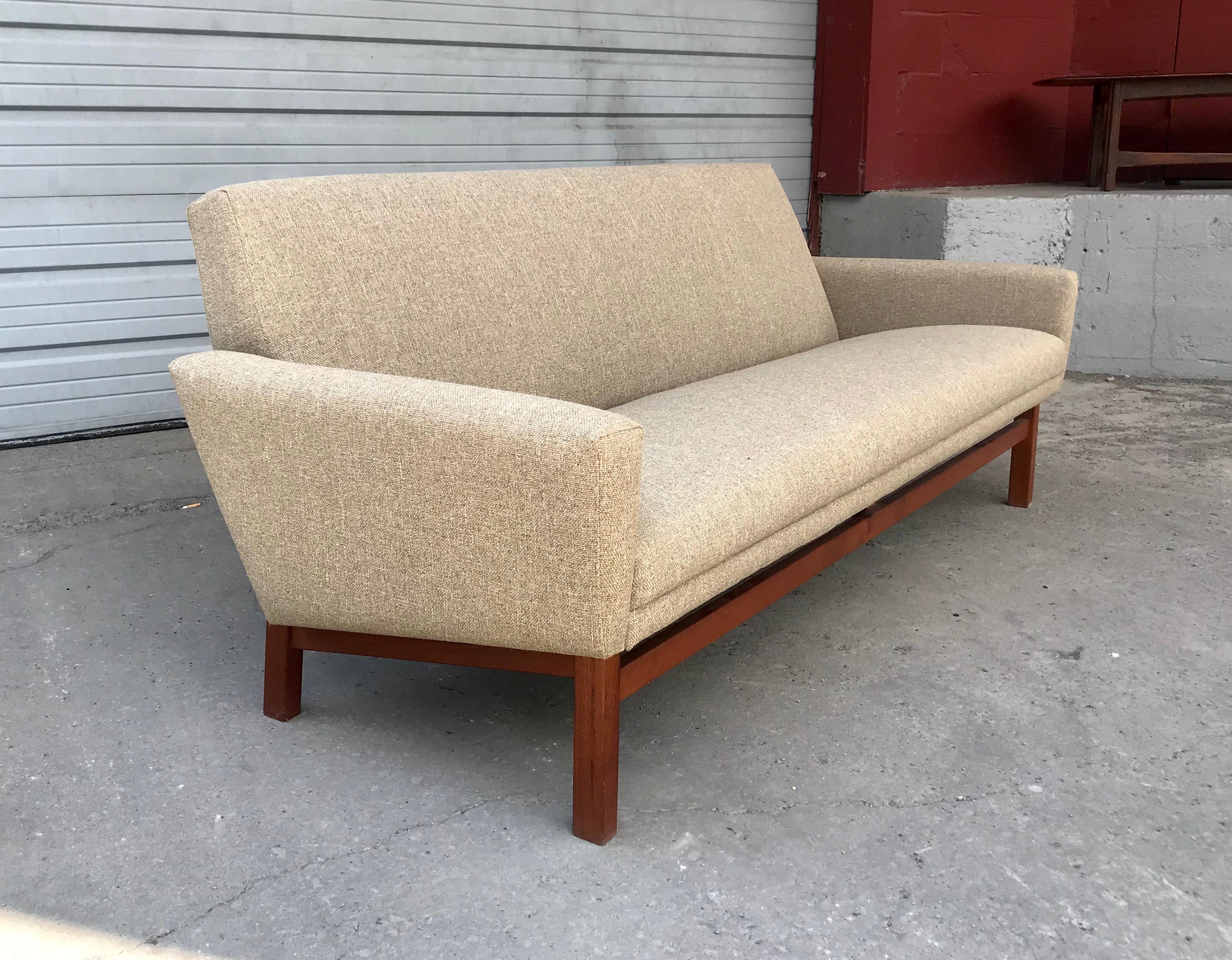 Classic Danish modern sofa, teak wood base and oatmeal color wool upholstery, stunning lines, extremely comfortable, Hand delivery avail to New York City or anywhere en route from Buffalo NY.