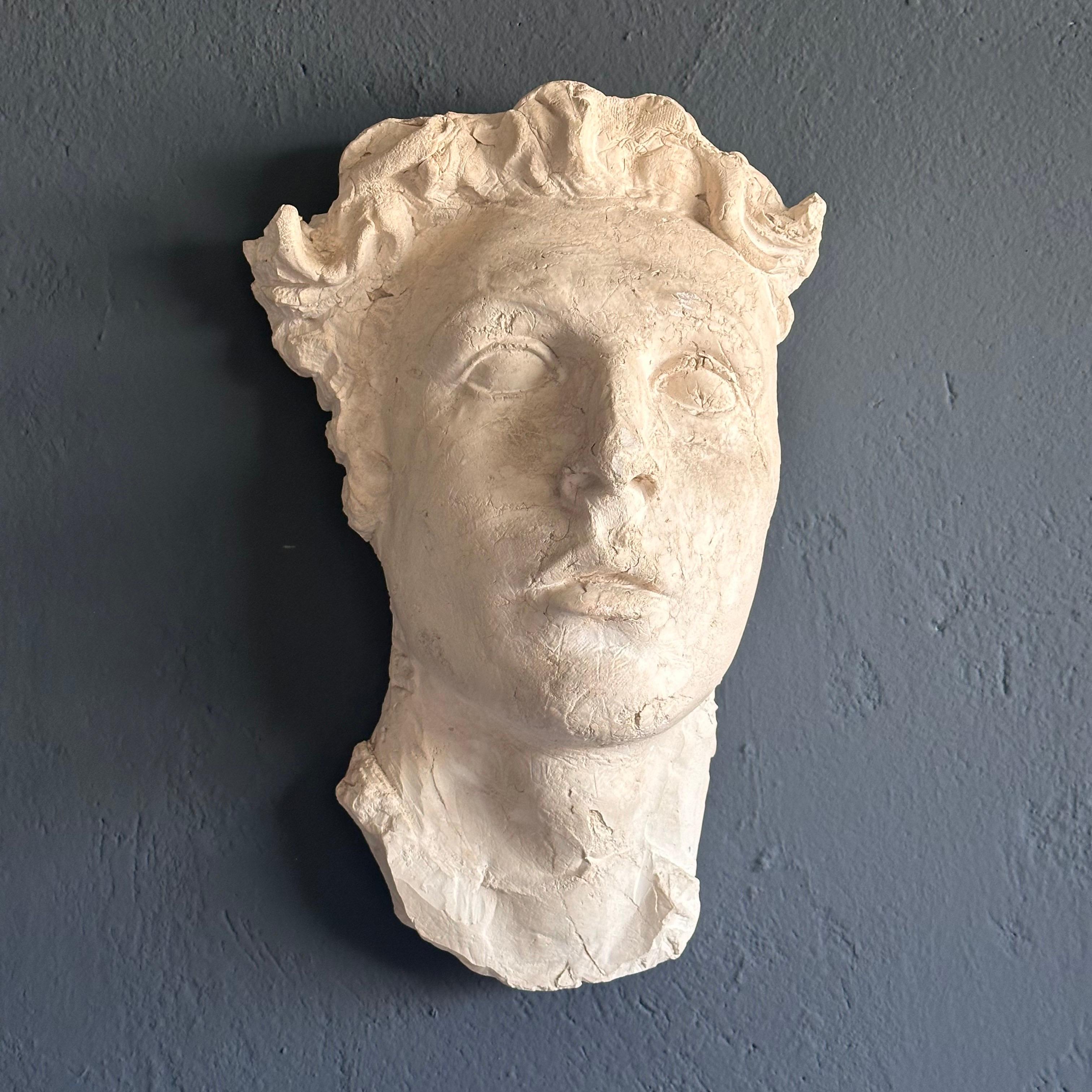 
Transport yourself to ancient Rome with this exquisite decorative gypsum face, a faithful reproduction from the 1970s that captures the timeless allure of classical art. Crafted with meticulous attention to detail, this piece embodies the elegance