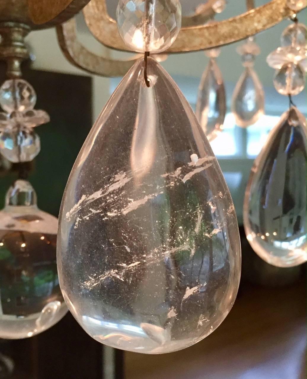 Magnificent contemporary high end designer chandelier having silver leaf finish on iron six arm frame with candle lights and stunning huge rock crystal tear drops. Has chain extension of additional 12 inches and matching ceiling cap. 

Purchased