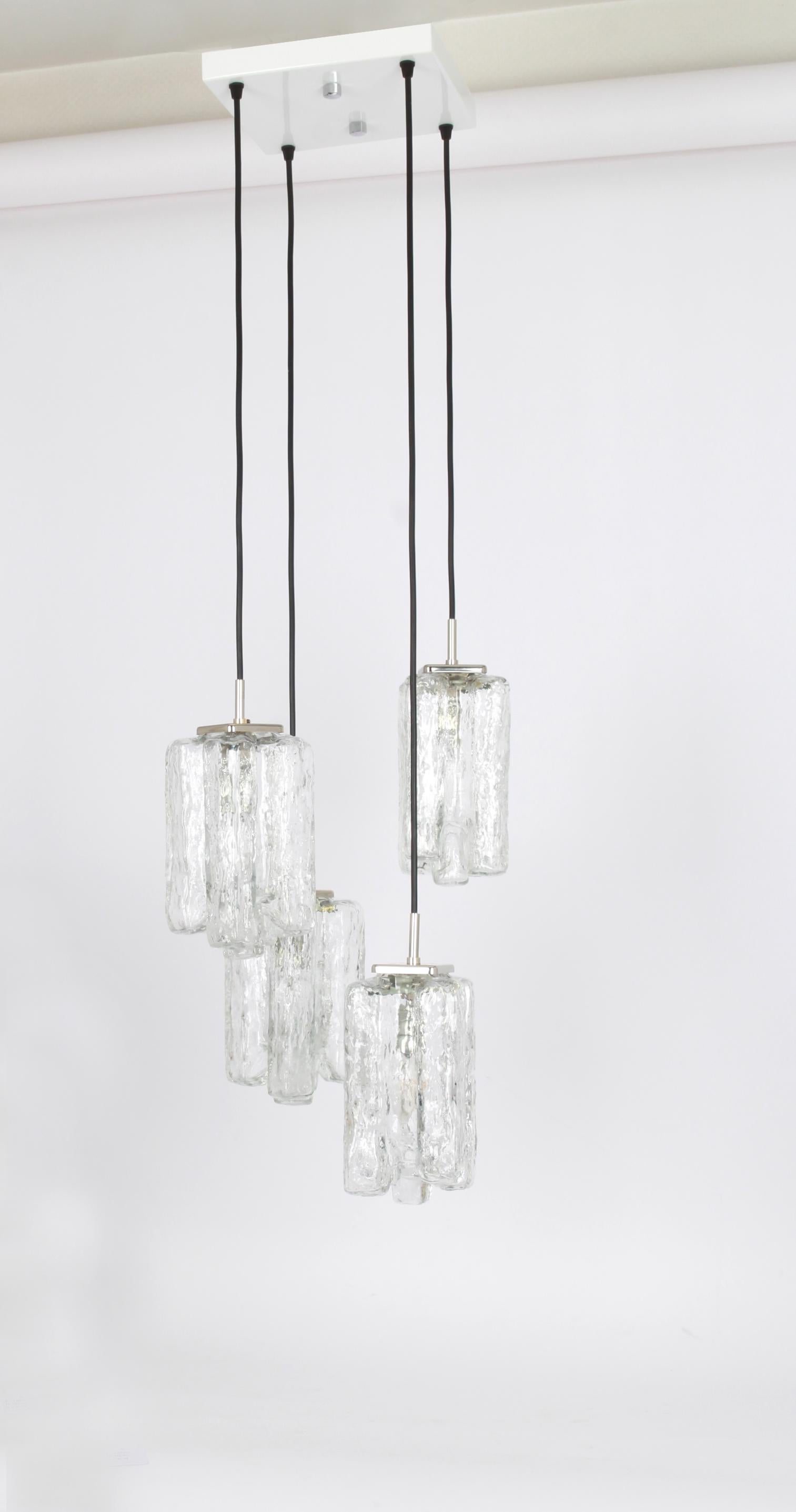A special cascading chandelier designed by Kalmar, manufactured in Austria, circa 1970s with 4 textured Murano glasses.
Stunning light effect.
Sockets: 4 x E14 small bulb. (each 40 W max).
Light bulbs are not included. It is possible to install