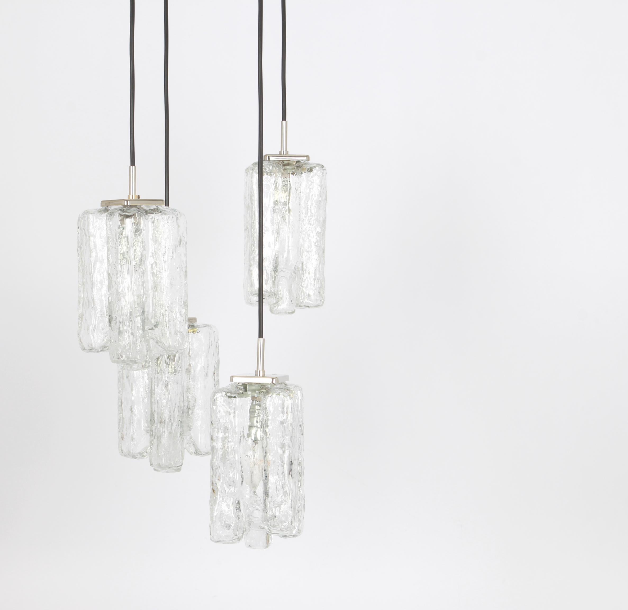 A special cascading chandelier designed by Kalmar, manufactured in Austria, circa 1970s with 4 textured Murano glasses.
stunning light effect.
Sockets: 4 x E14 small bulb. (each 40 W max).
Light bulbs are not included. It is possible to install