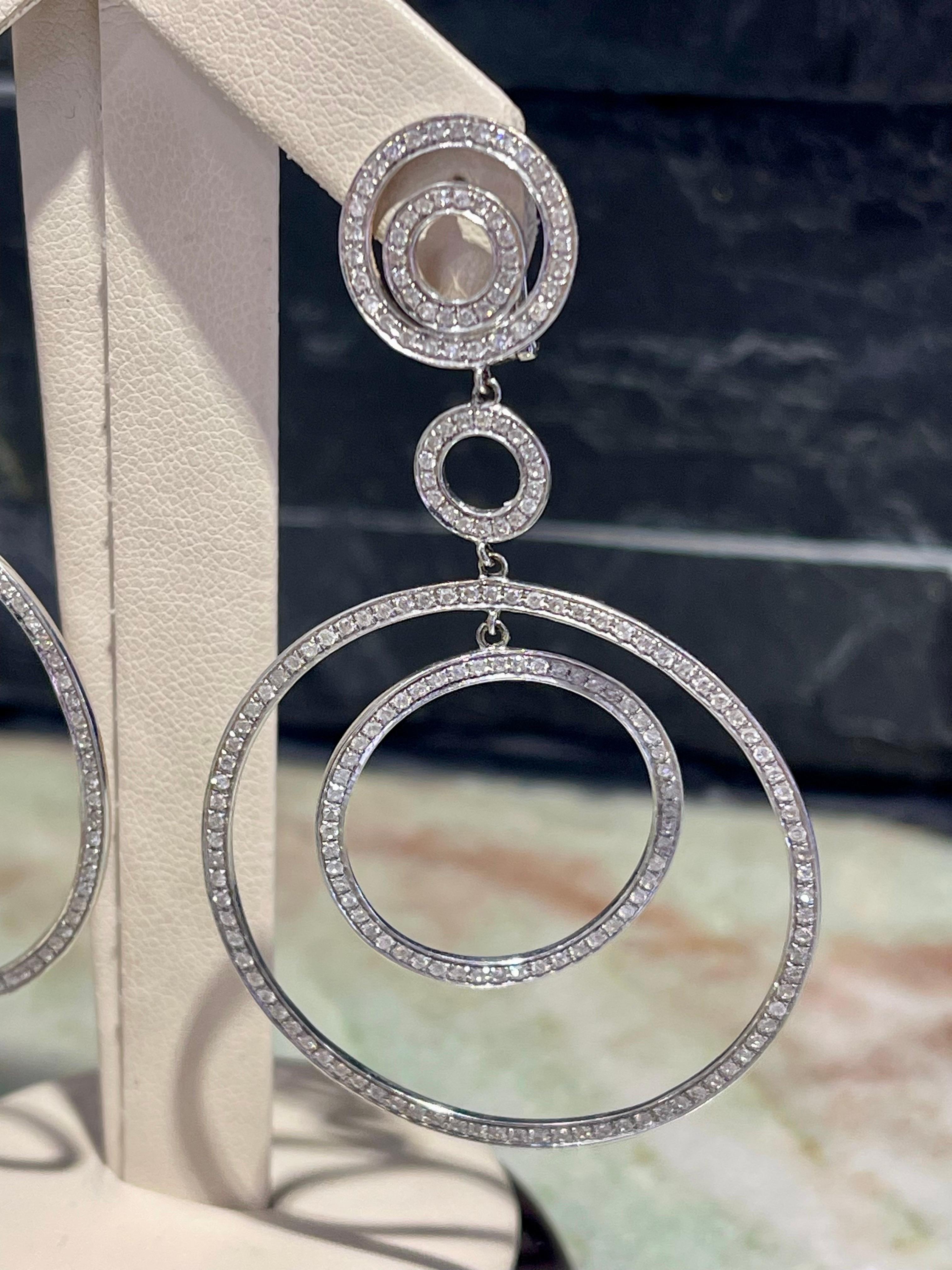 Stunning Diamond Drop Earrings In 14k White Gold ,

Approximately 4 carats in diamonds,

Hanging length is 2.75”,

Diameter of the largest circle is 1.5”

Omega clasp