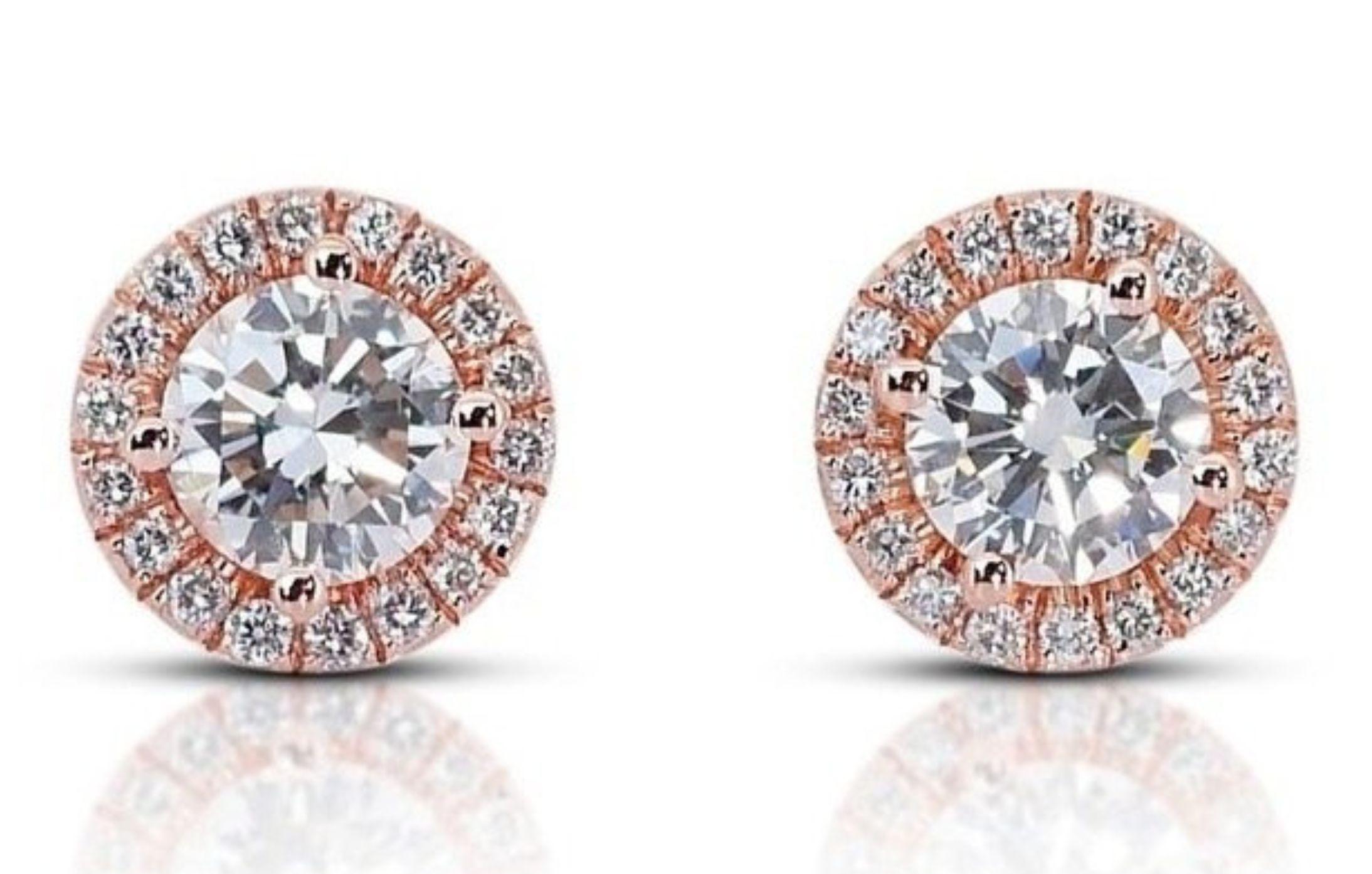 These stunning diamond earrings are the perfect addition to any jewelry collection. The 1.2 carat round brilliant main stone is dazzling and eye-catching, and the 0.2 carats of side diamonds add even more sparkle and brilliance. The earrings are