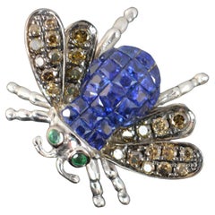 Stupendo anello con diamante, zaffiro e smeraldo in oro bianco 18ct.