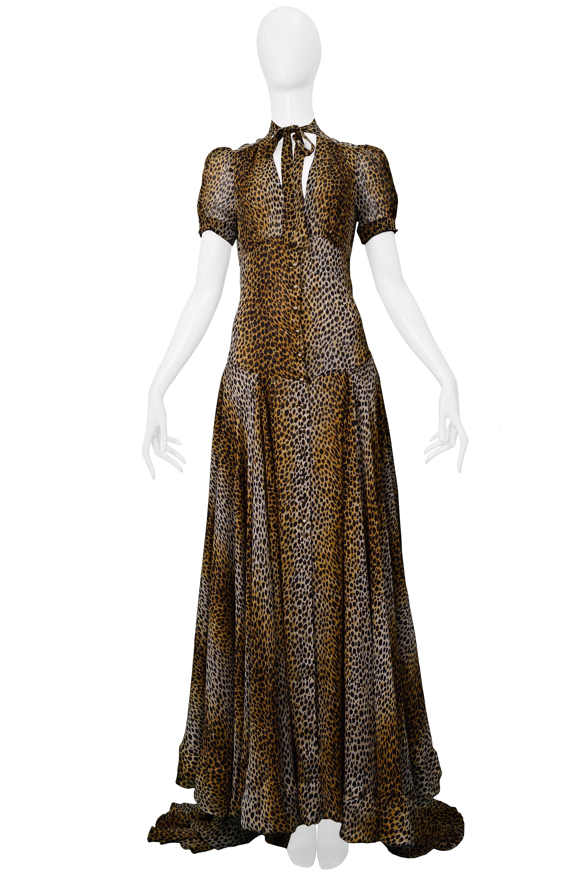 Resurrection is excited to offer a vintage Dolce & Gabbana D&G leopard print evening gown featuring a keyhole front, necktie, gold buttons, short sleeves, semi-sheer fabric, full-length skirt with a longer train panel in the back. 

Dolce & Gabbana