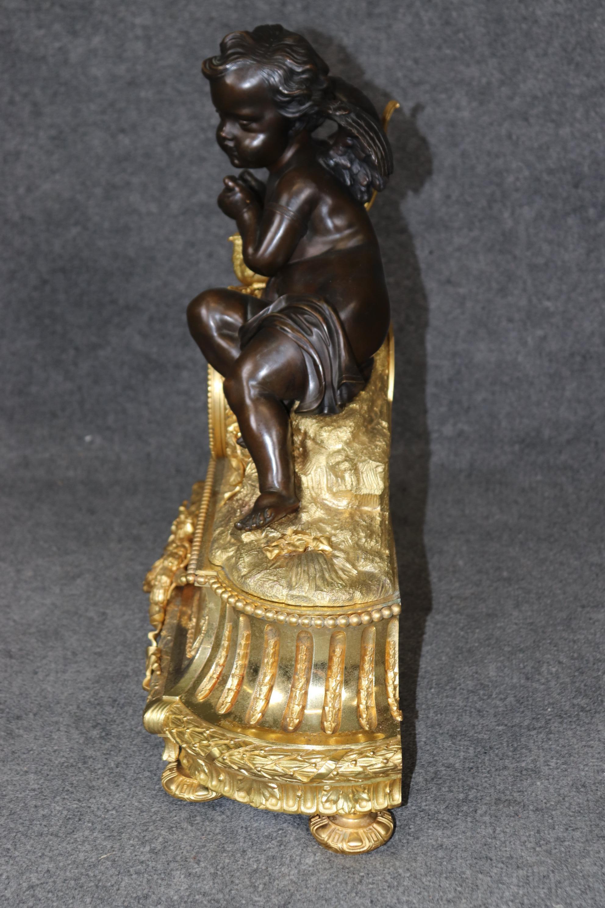 This is a spectacular mantel clock by Vannier of Paris and is signed on the procelain dial. The clock features some of the finest bronze castings we've ever seen on a mantel clock. The clock depicts a dark bronze patina winged cherub and birds with