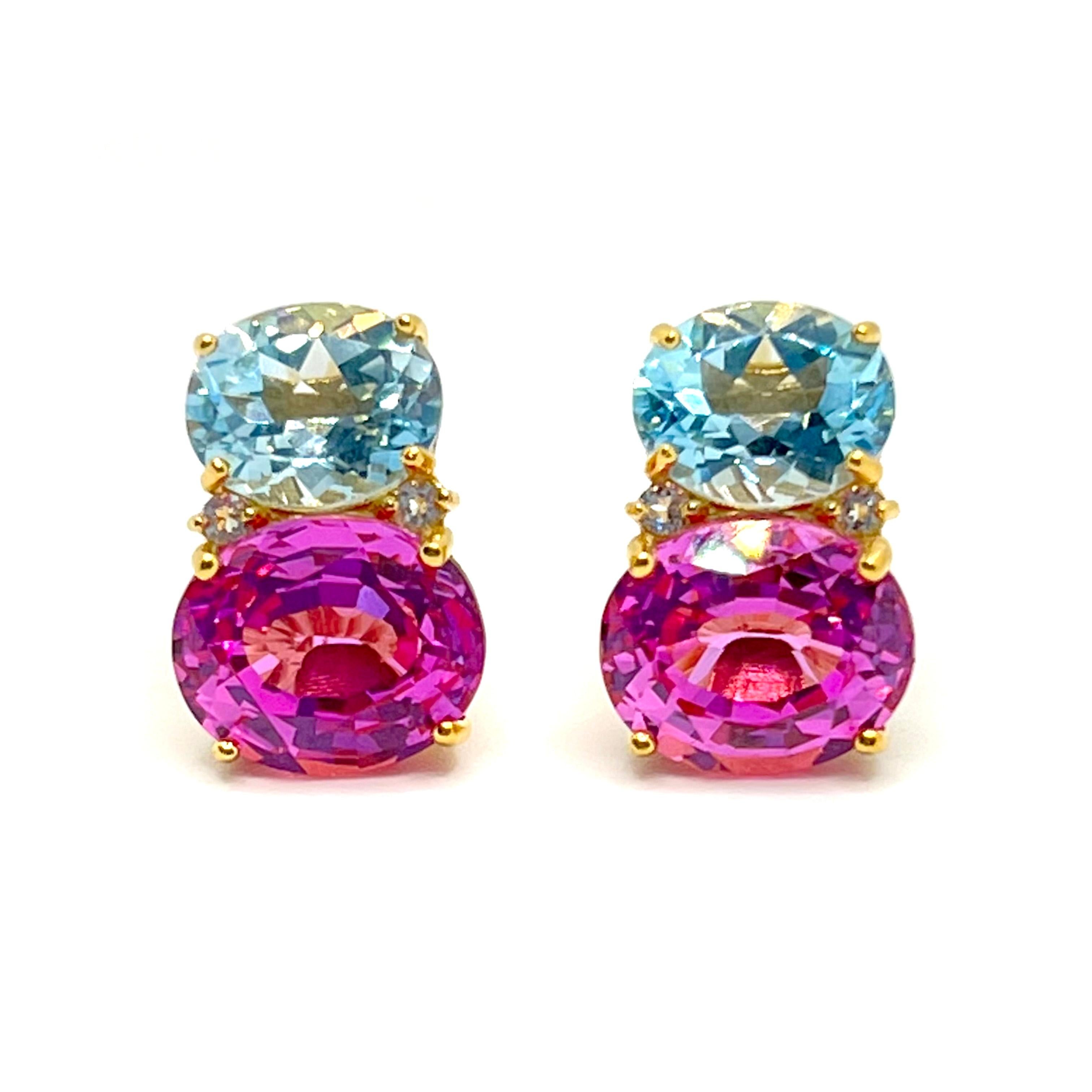 These stunning pair of earrings features a pair of oval sky blue topaz, lab-grown pink sapphire, adorned with round white topaz on the side, handset in 18k yellow gold vermeil over sterling silver. The two-tone blue combination just look so great