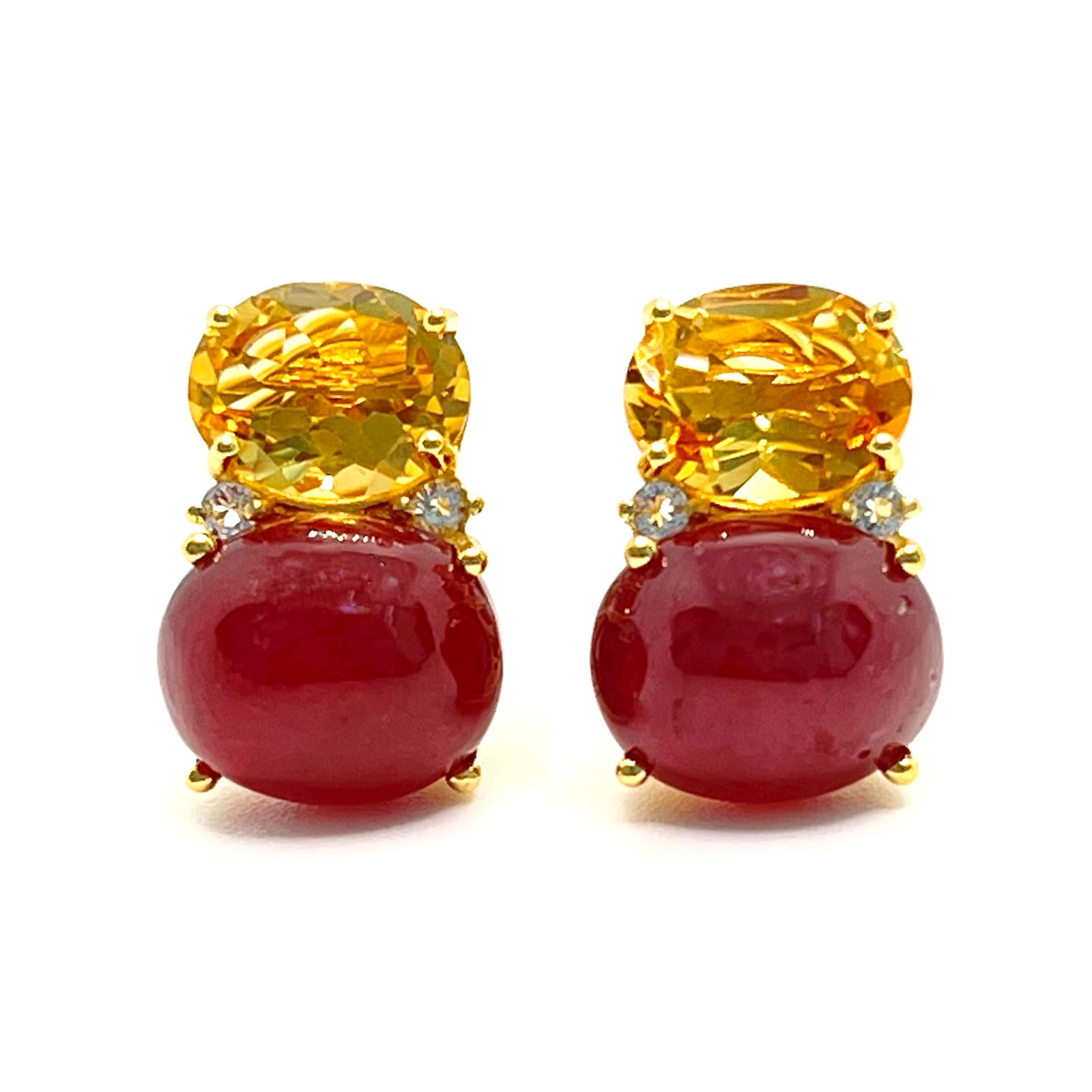 These stunning pair of earrings features a pair of genuine oval citrine, genuine cabochon-cut African ruby, adorned with round white topaz on the side, handset in 18k yellow gold vermeil over sterling silver. The beautiful yellow/pink-ish red