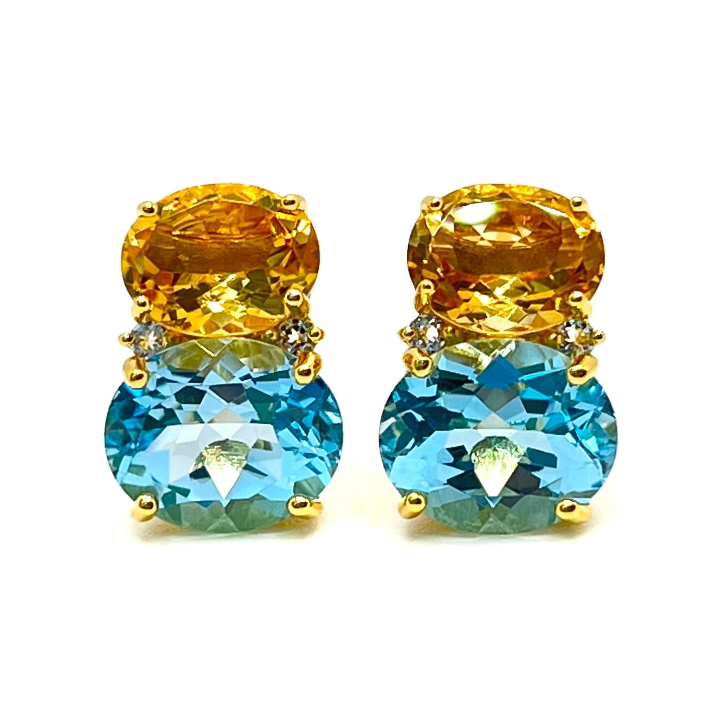 These stunning pair of earrings features a pair of genuine oval citrine, sky blue topaz, adorned with round white topaz on the side, handset in 18k yellow gold vermeil over sterling silver. The beautiful yellow/blue combination - they just look so