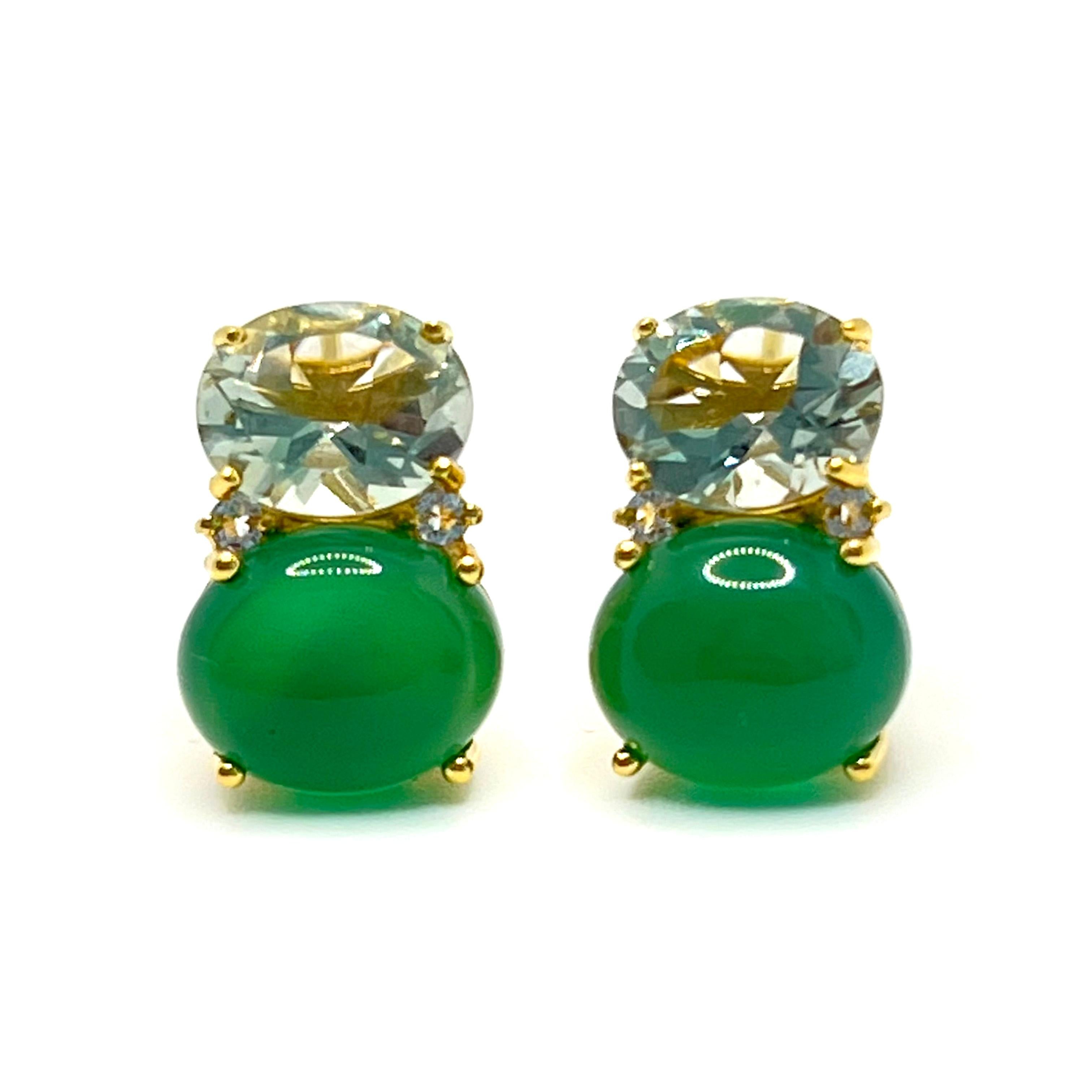 These stunning pair of earrings features a pair of genuine oval pastel green prasiolite, cabochon-cut green agate adorned with round white topaz on the side, handset in 18k yellow gold vermeil over sterling silver. The two-tone green combination