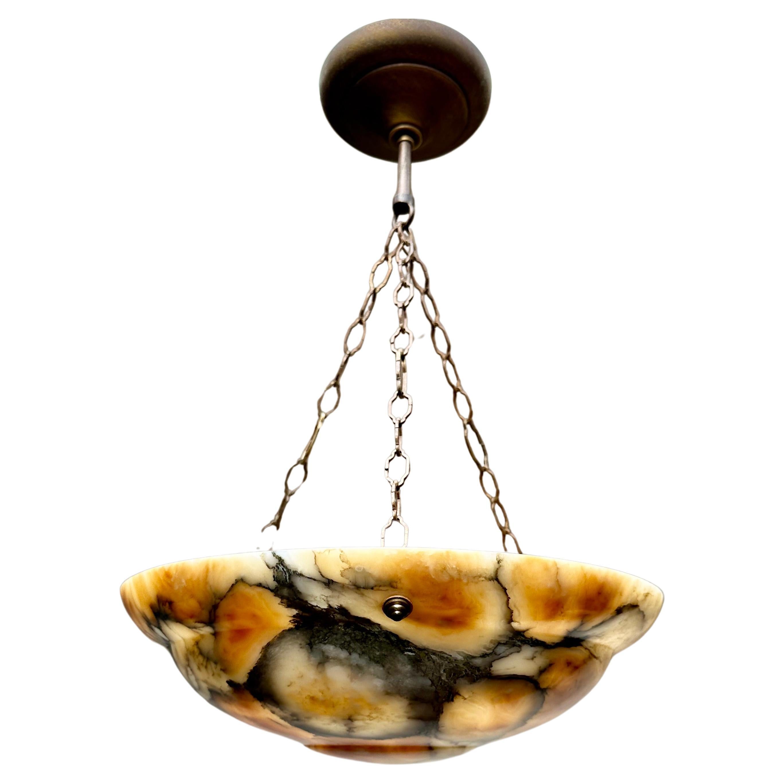 Great shape and warmest color alabaster light with adjustable canopy.

If you are looking for a truly beautiful and good quality condition alabaster pendant then this colorful striking specimen could be the one or you. This regular size, but